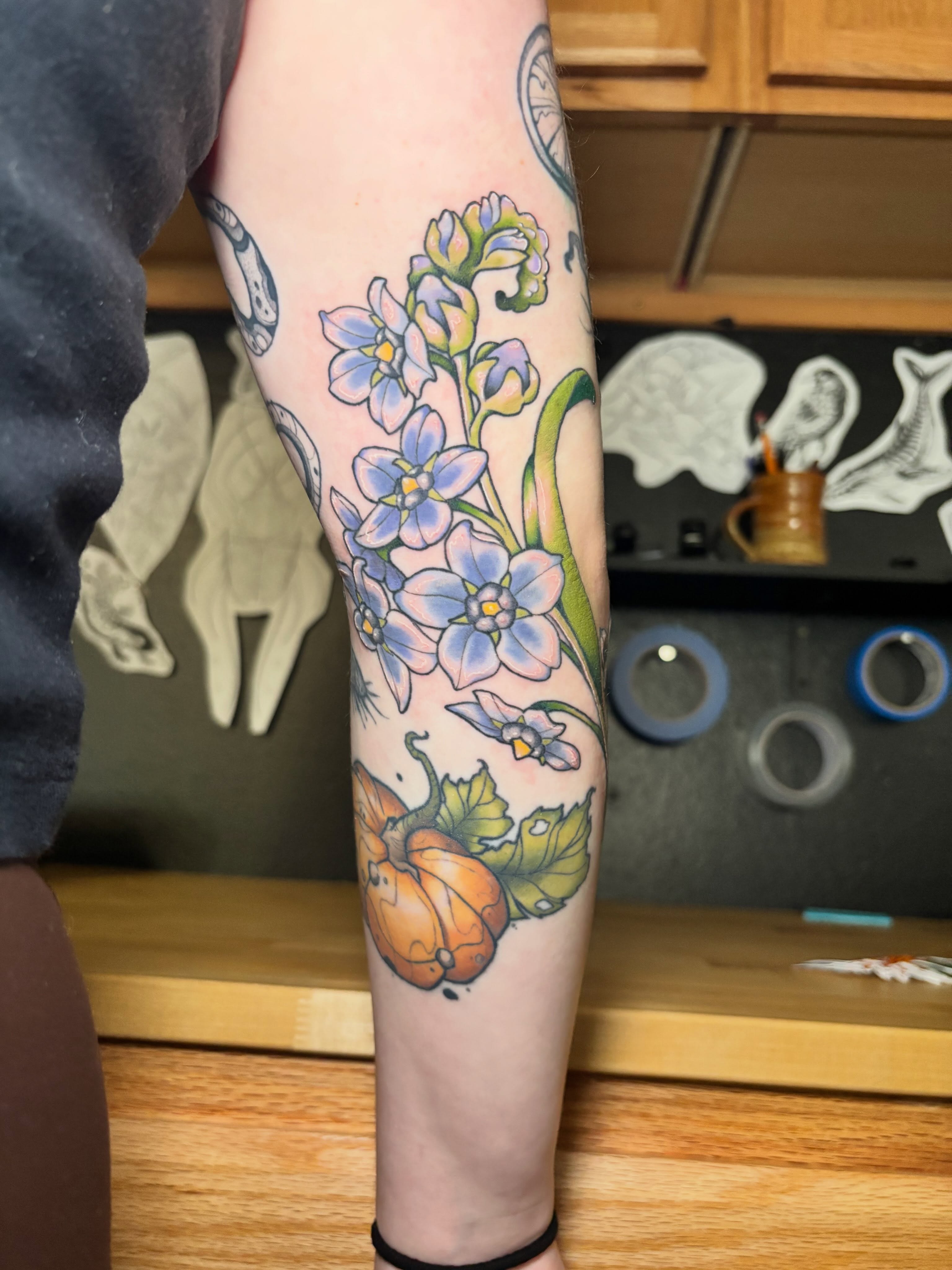 Flowers and pumpkin new school tattoo on the forearm by Wren Hollow, Portland, Oregon