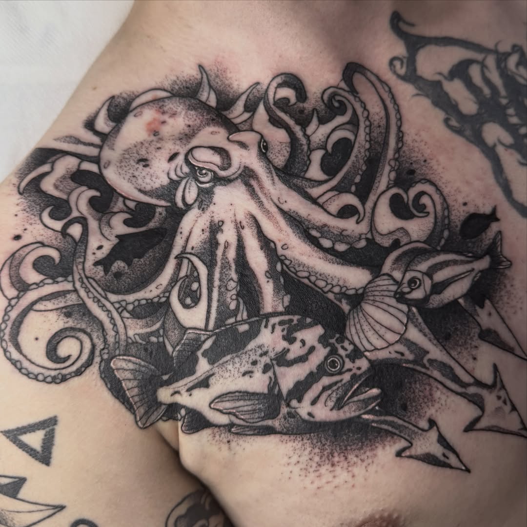 Octopus and fish dotwork tattoo on the chest by Aiden Shaw