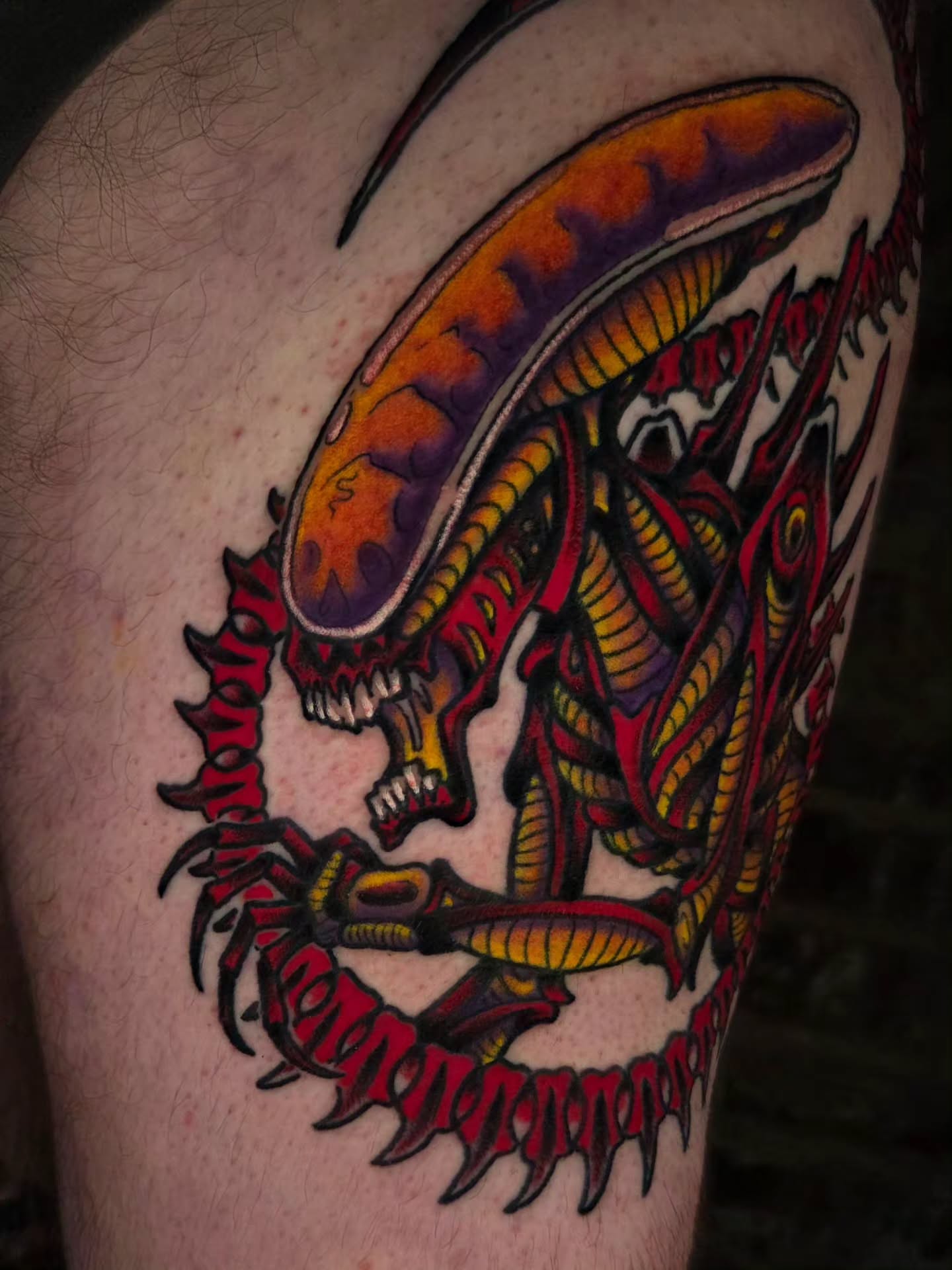 Alien xenomorph American traditional tattoo on the thigh by Ian Kiser