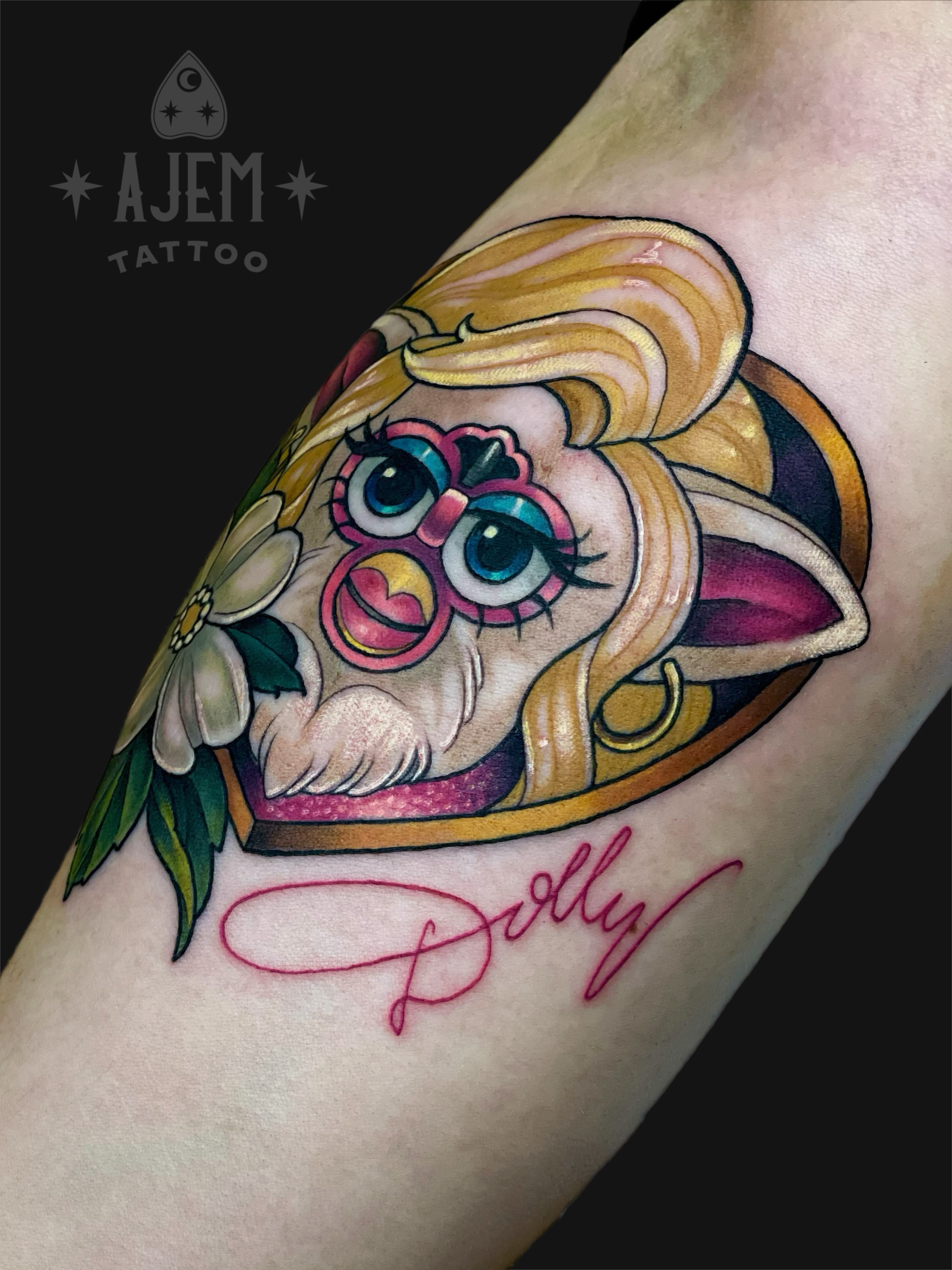 Doll illustrative tattoo on the forearm by Ash MacIsaac
