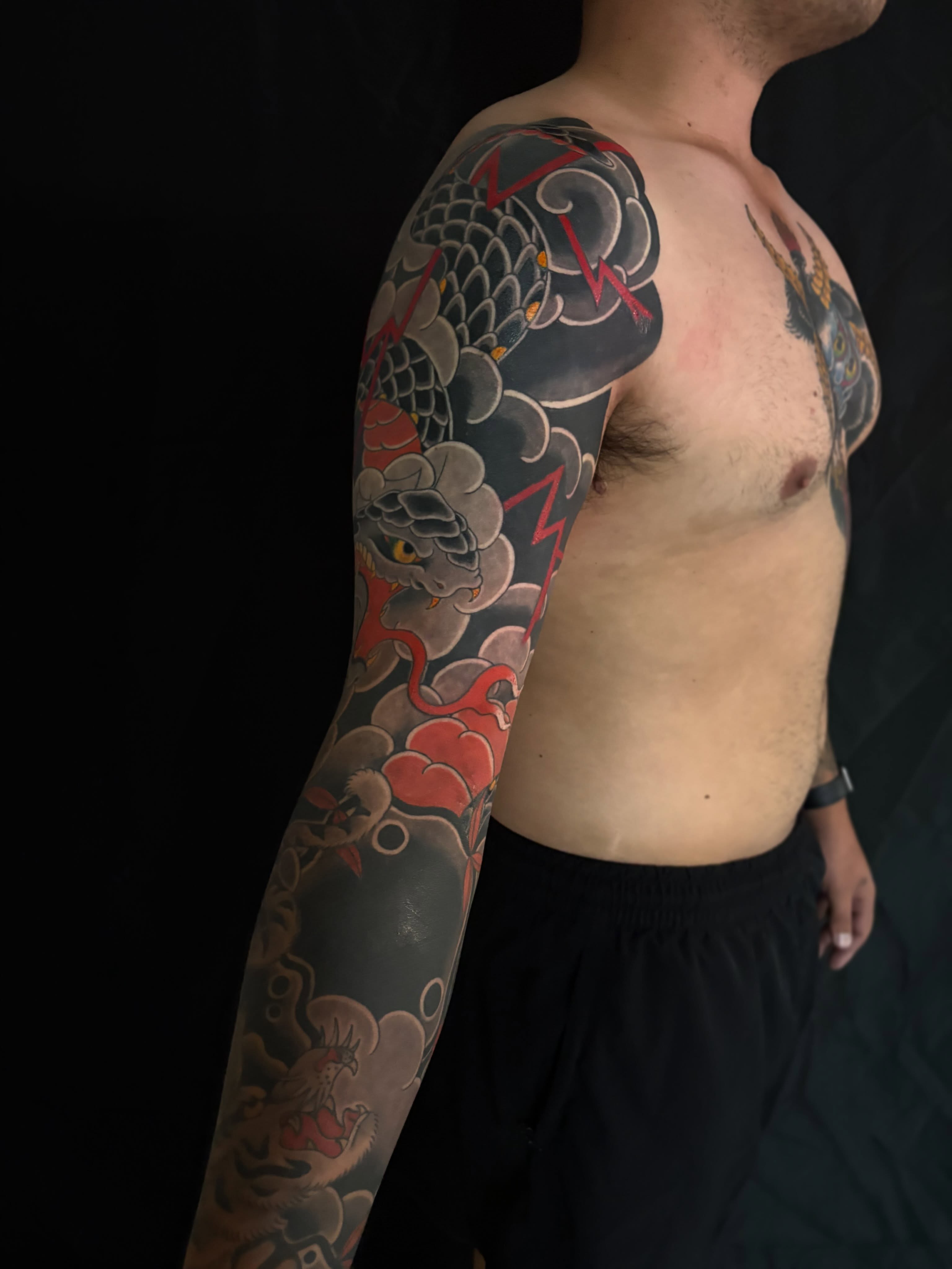 Dragon and clouds japanese irezumi tattoo on the upper arm by Zach Hendrickson