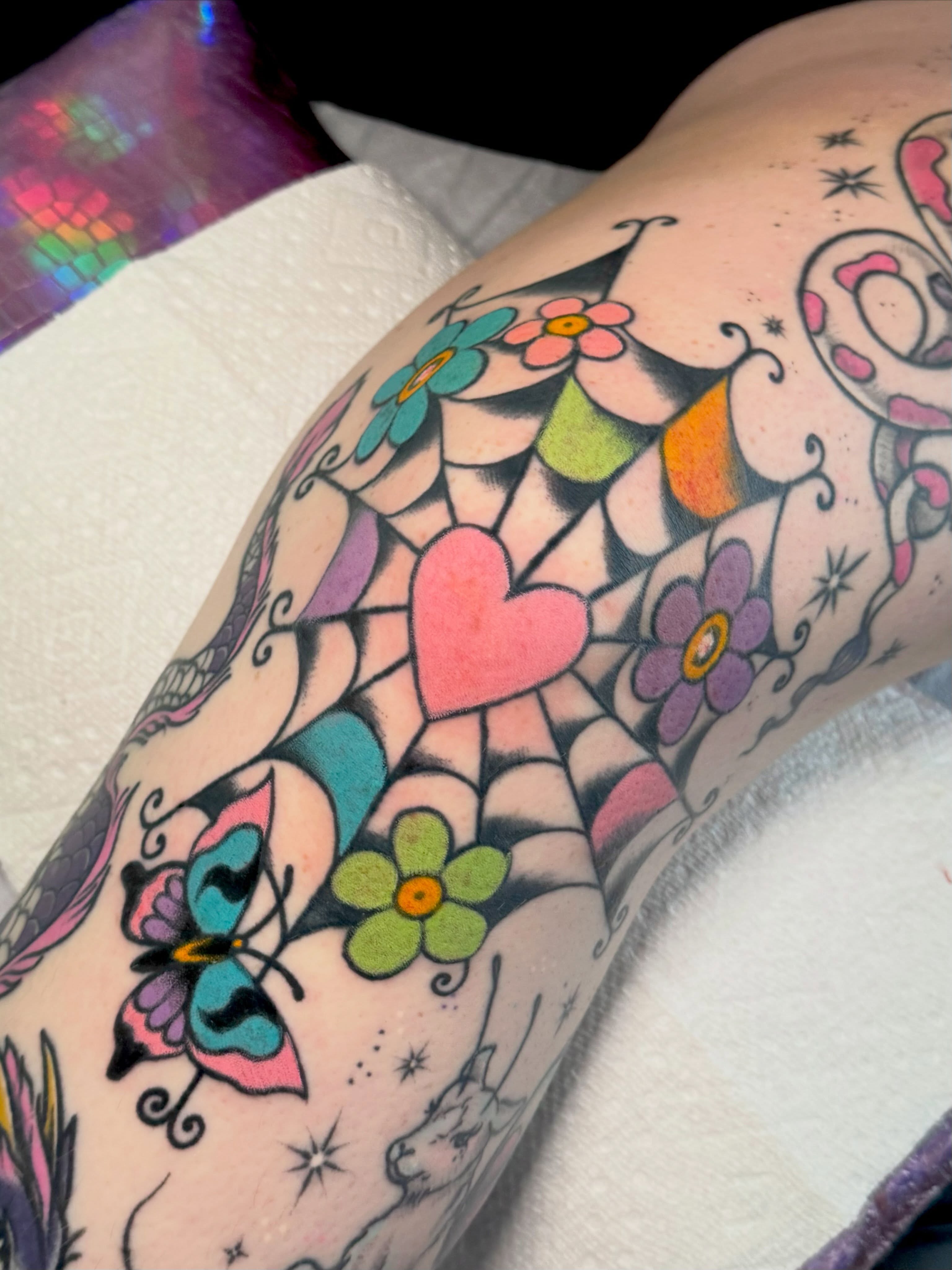 Heart and flowers American traditional tattoo on the forearm by Painted Peach Tattooer