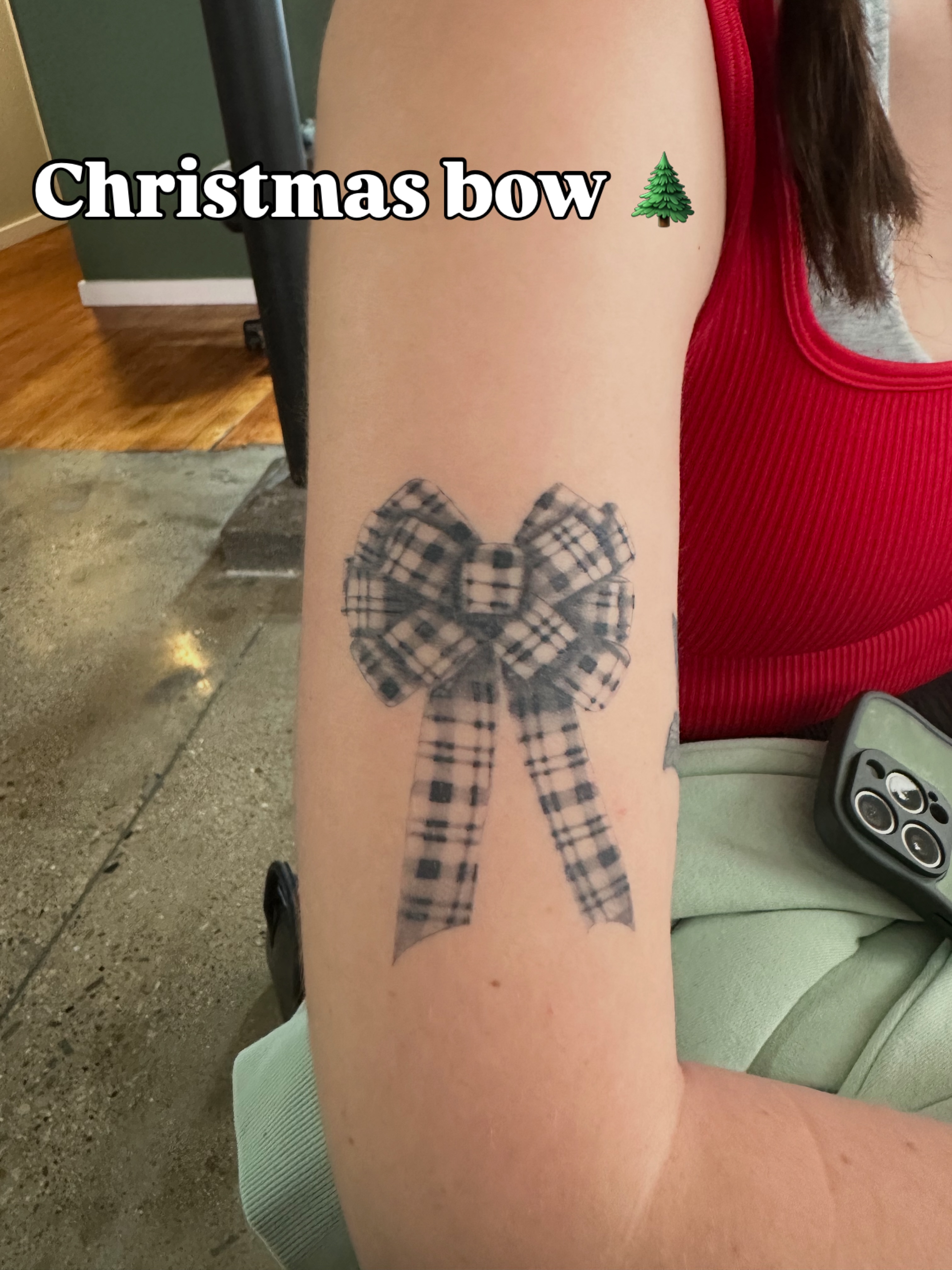 Christmas bow black and grey tattoo on the forearm by Tat by Brendan