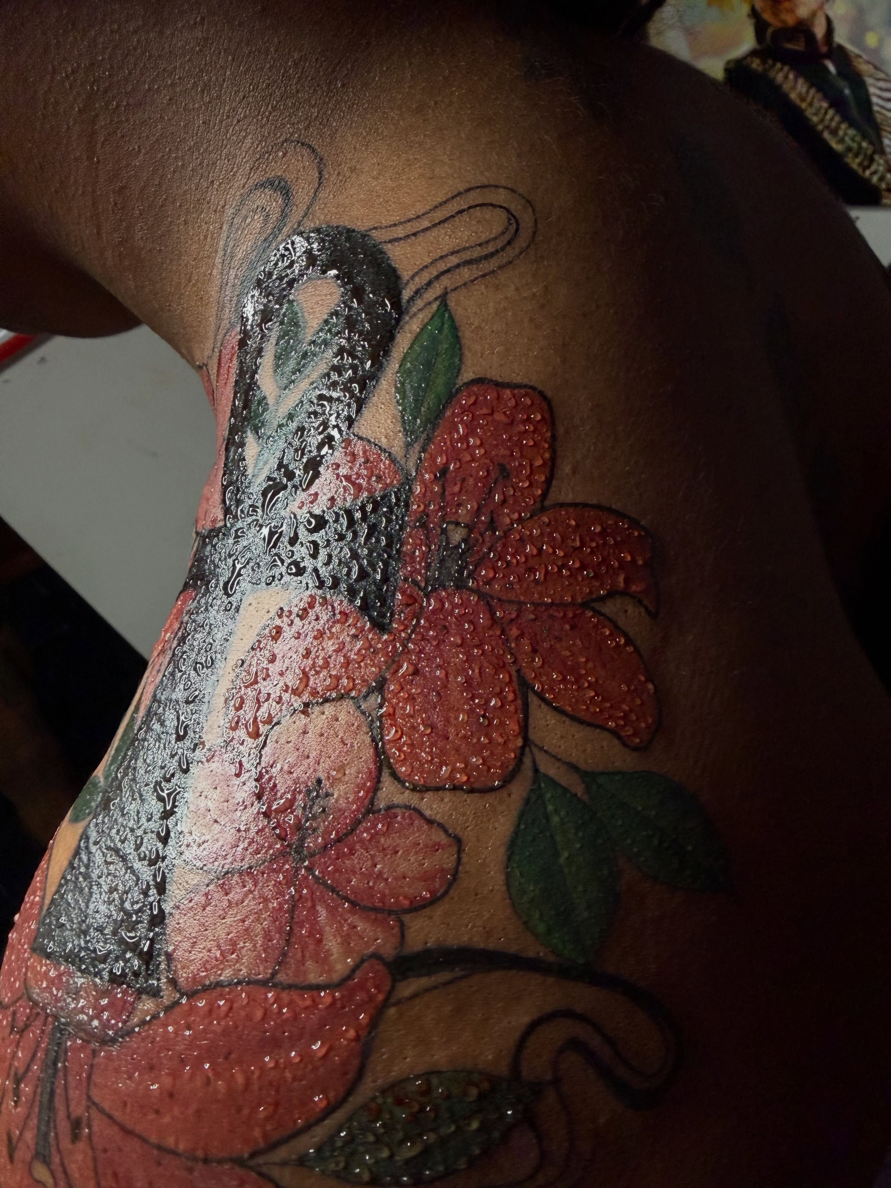 Flowers and butterfly watercolor tattoo on the shoulder by Doll The Tattoo Artist, Addison, Texas