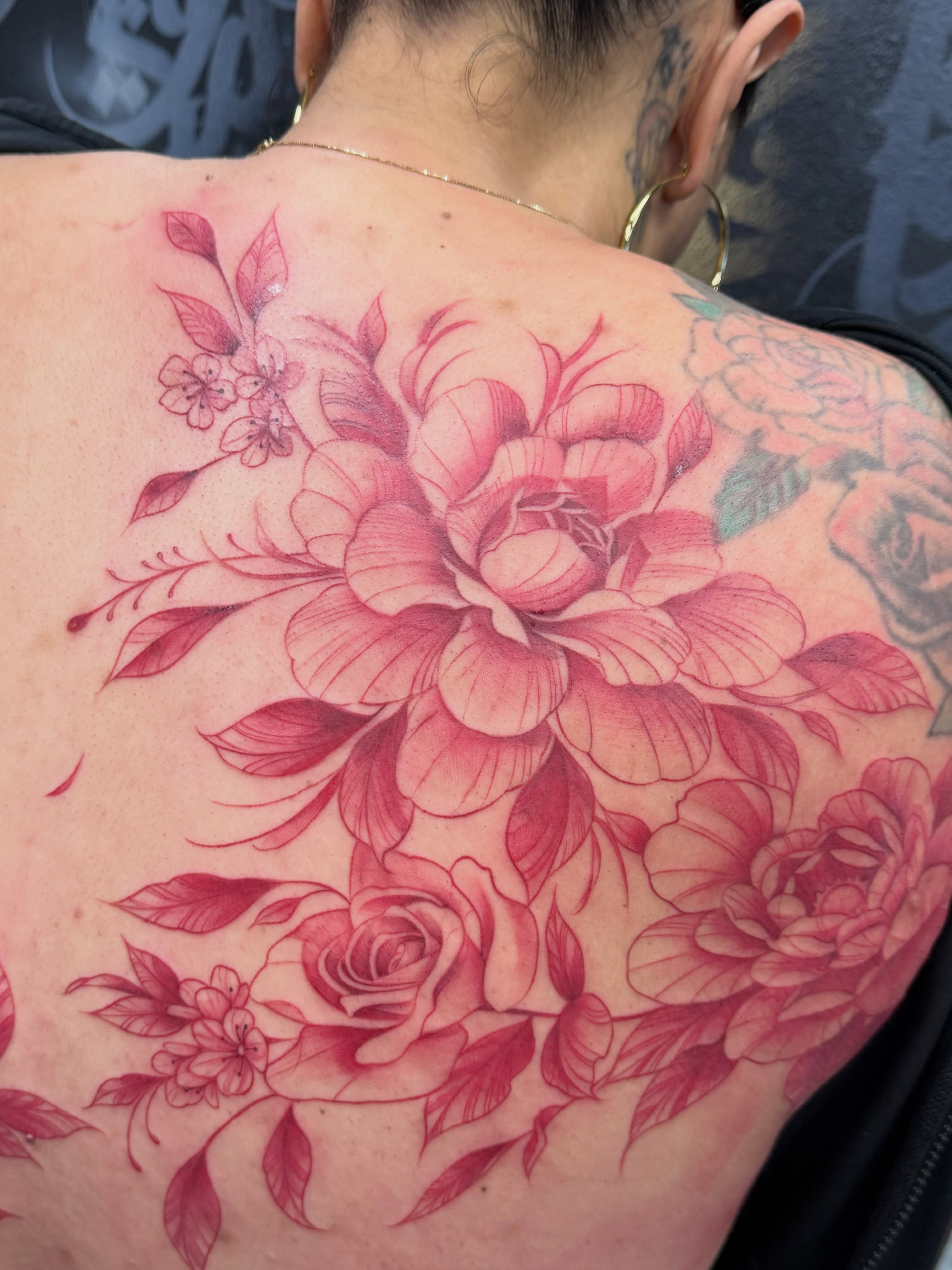 Floral bouquet realism tattoo on the back by Jennifer Flores