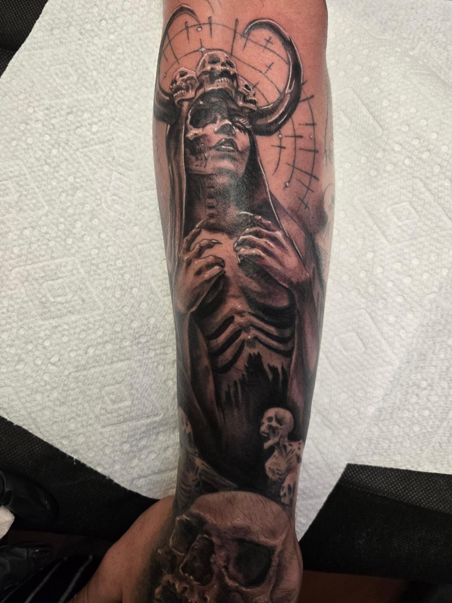 Skeleton with halo dark realism tattoo on the forearm by Irma π€β¨, Las Vegas, Nevada