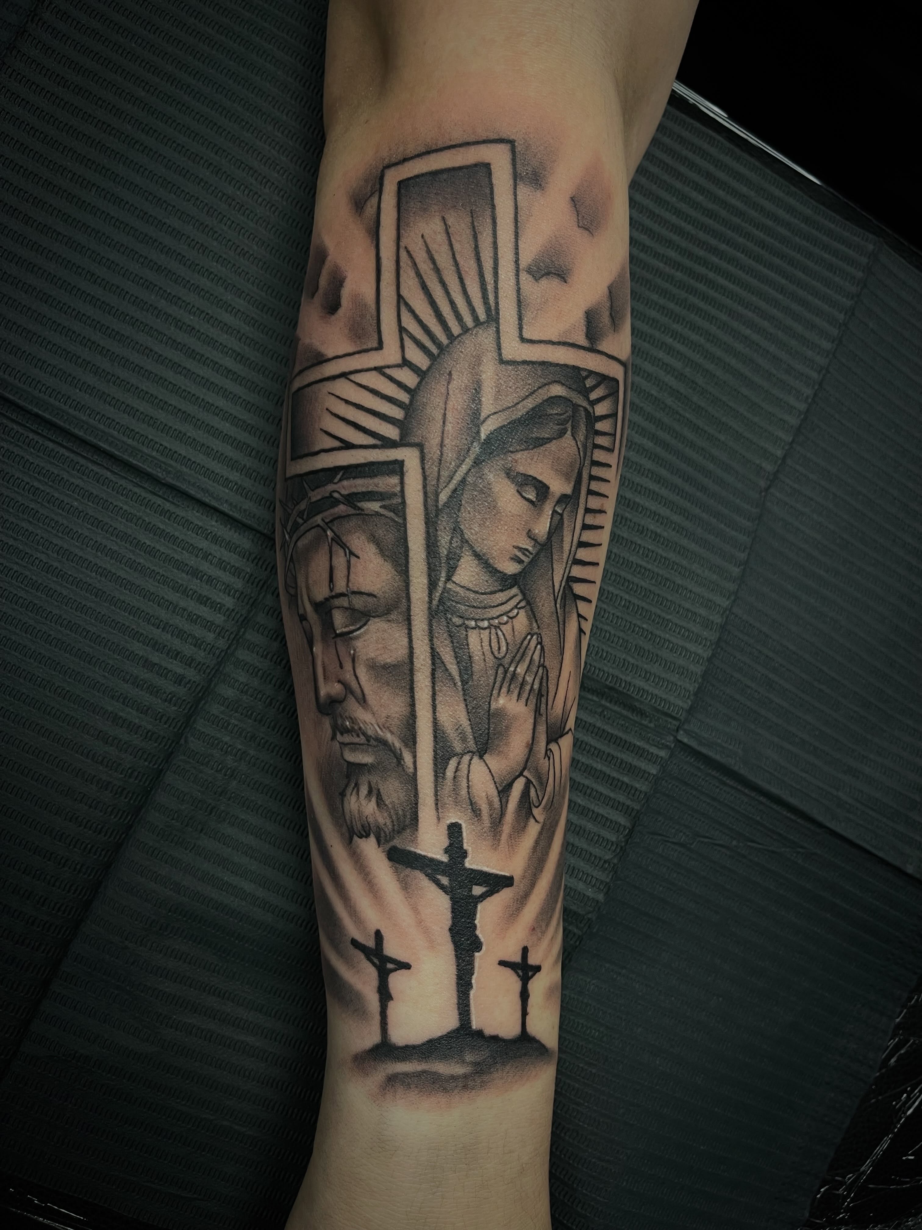 Religious triptych realism tattoo on the forearm by Chris Torres