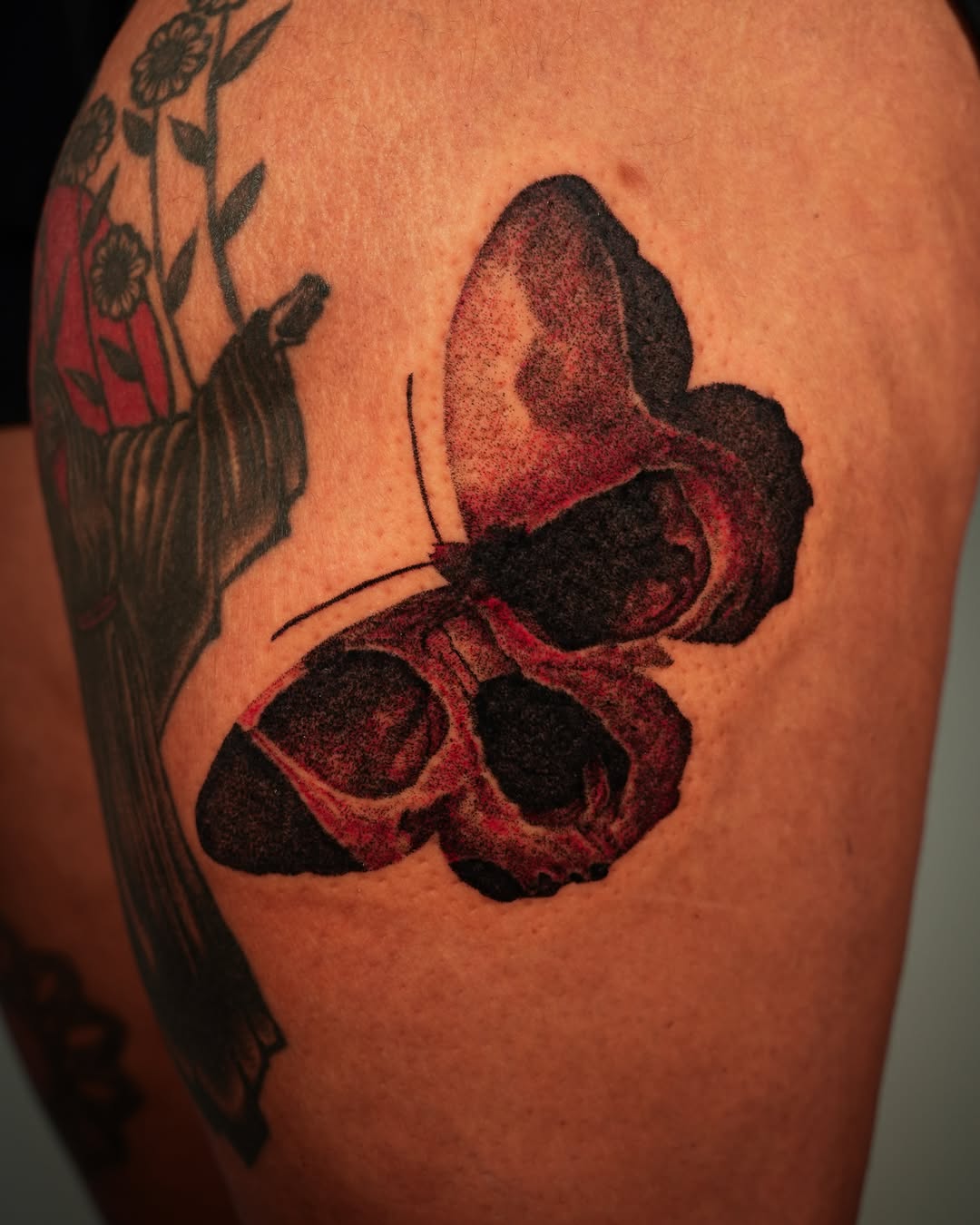 Butterfly dotwork tattoo on the upper arm by Tony Murray