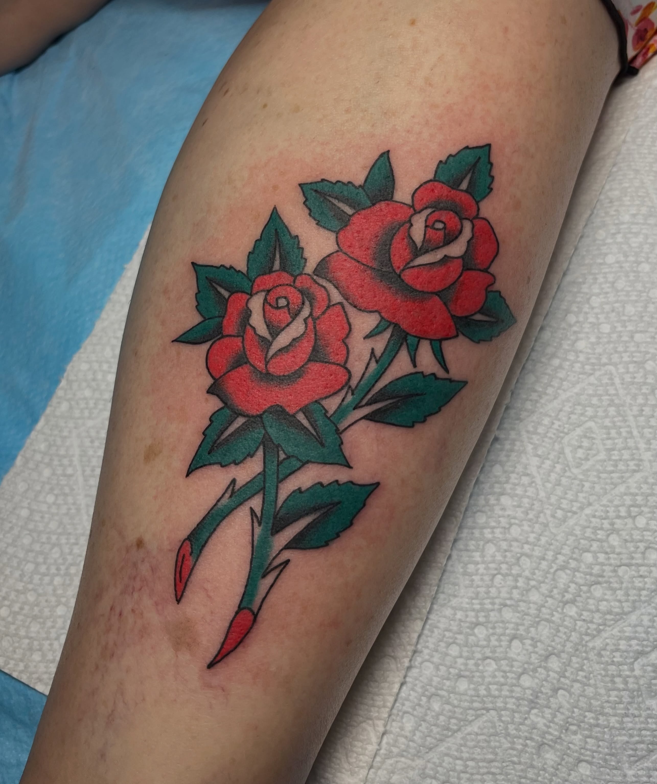 Roses American traditional tattoo on the forearm by Taylor Newton