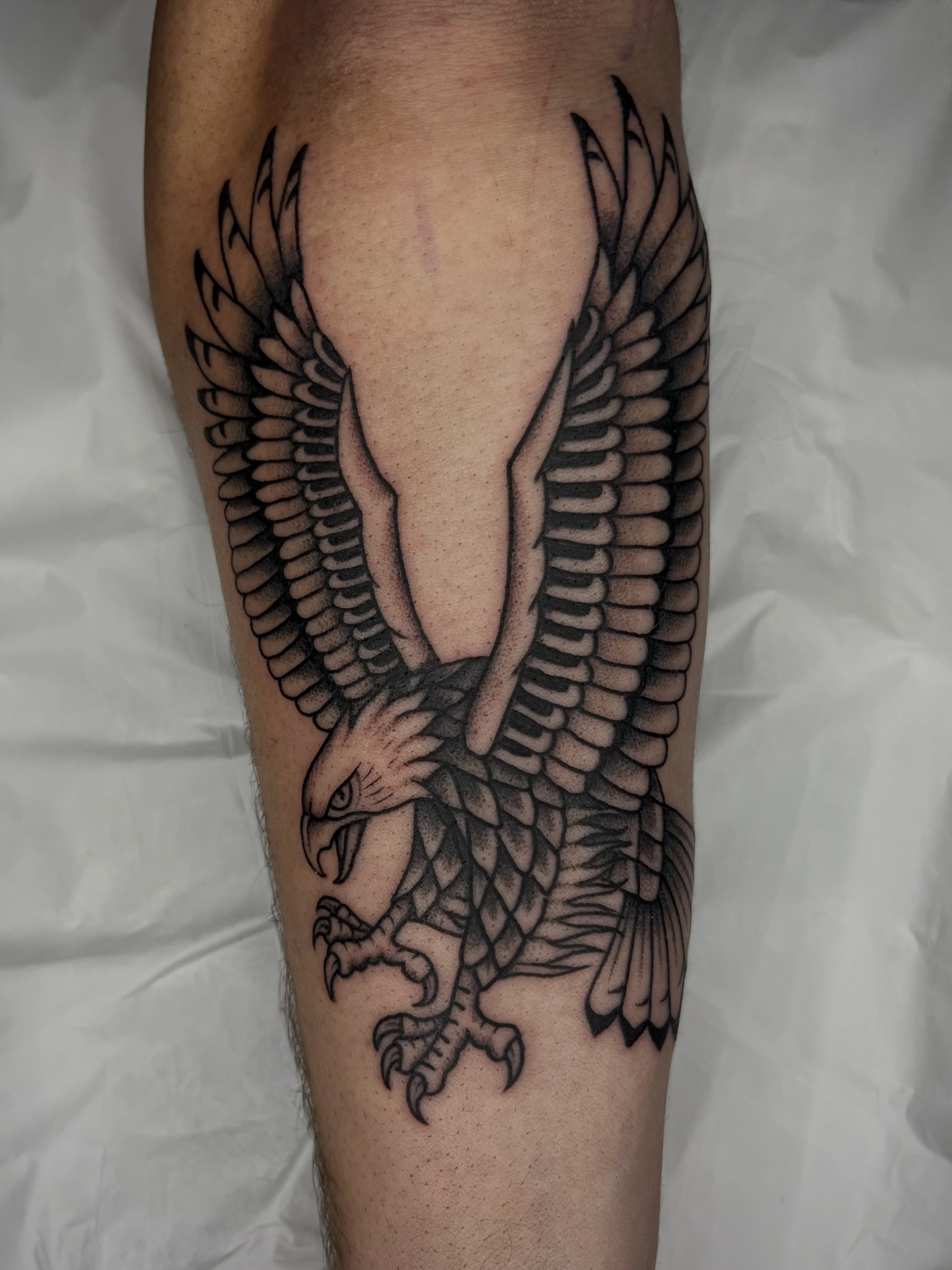 Eagle black and grey tattoo on the forearm by Patrick Elijah