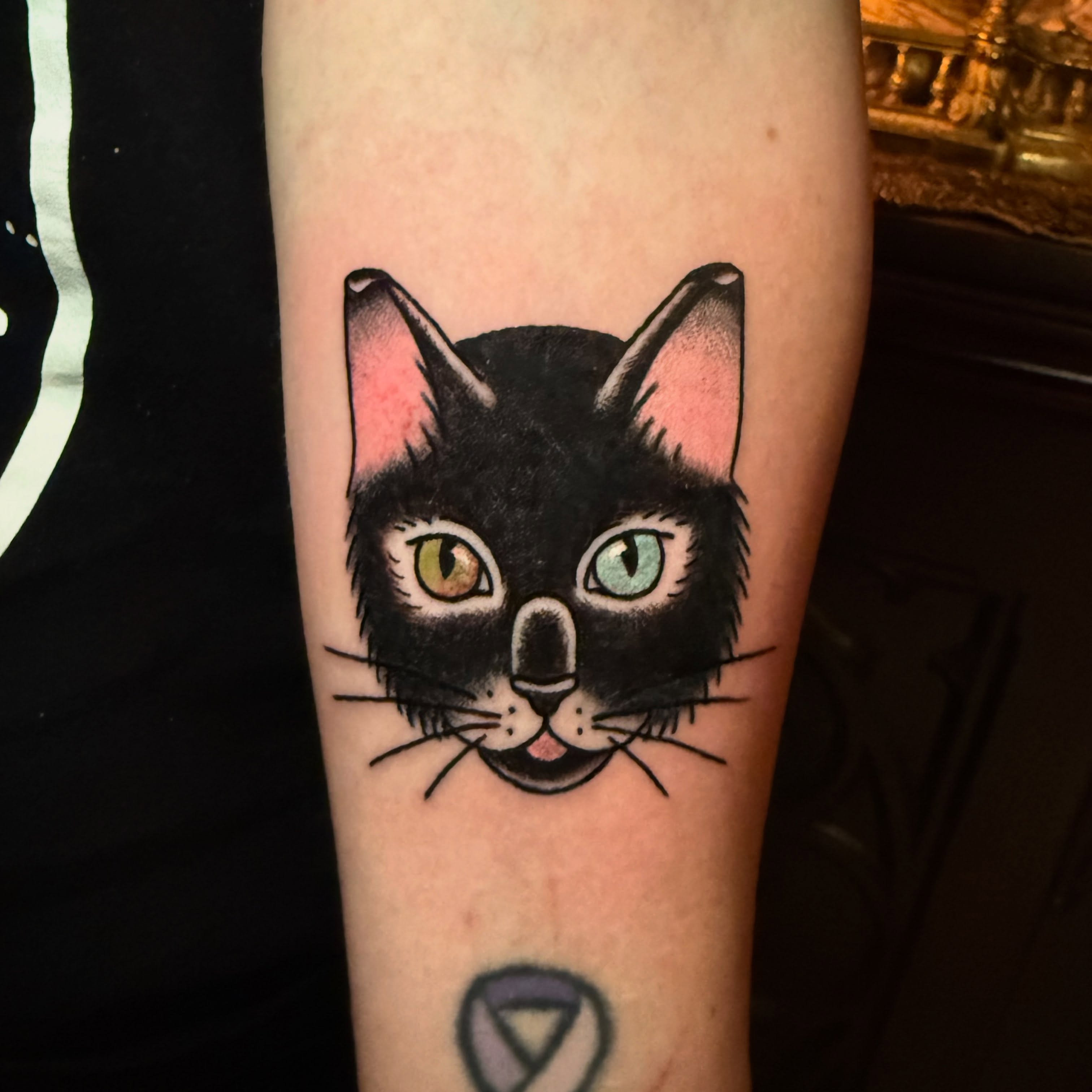 Cat face American traditional tattoo on the forearm by Emily Lestrange
