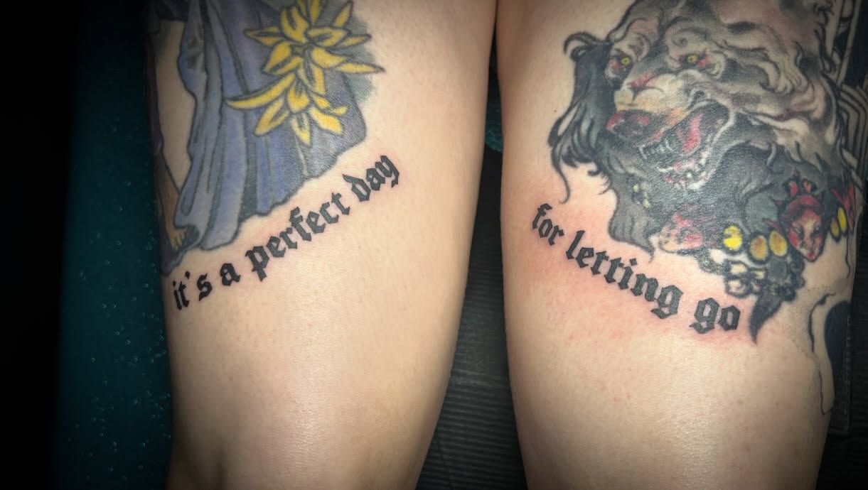 Flower and lion American traditional tattoo on the forearm by Tattoo Kayla