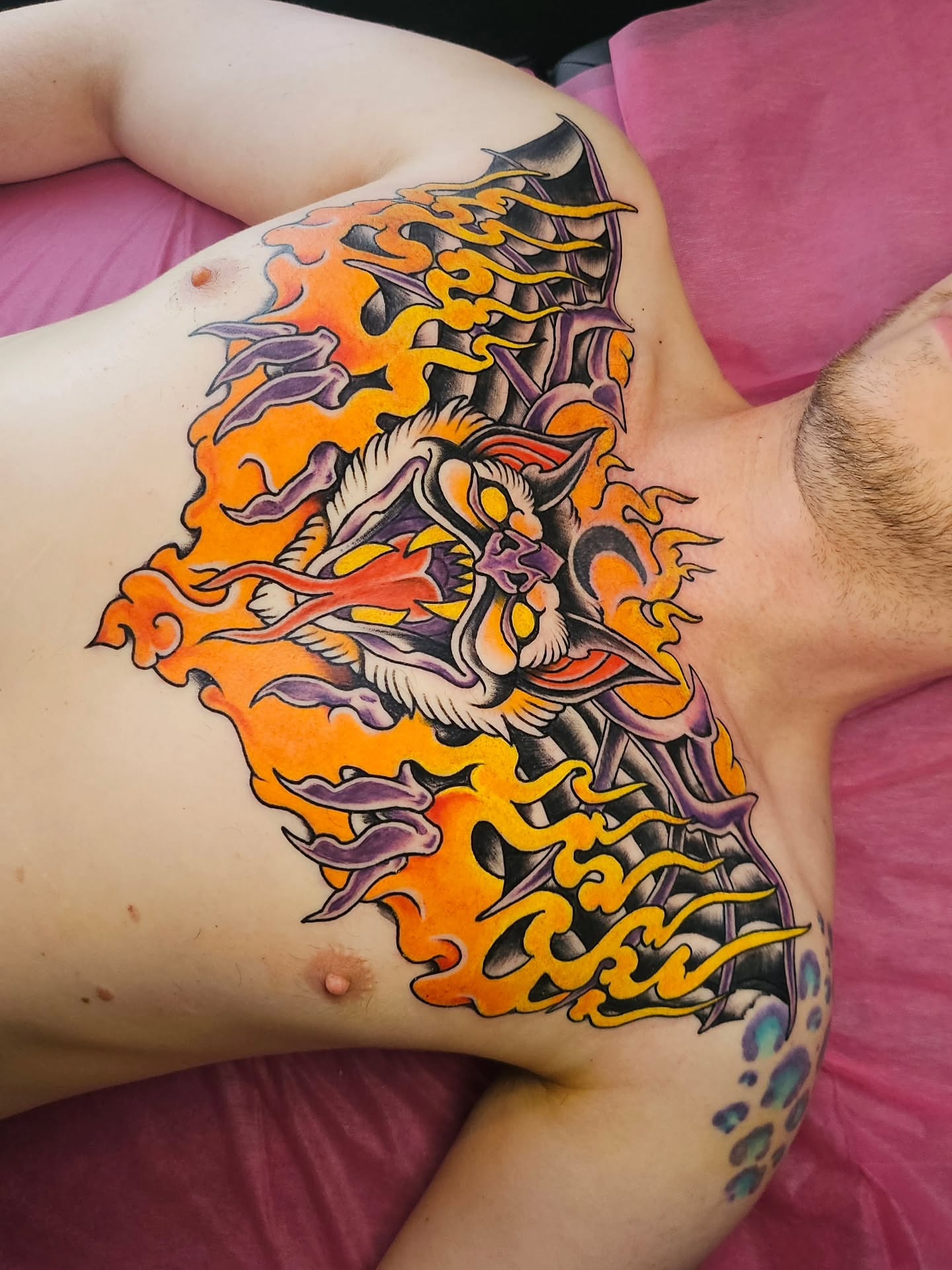 Flaming dragon japanese irezumi tattoo on the chest by Monaca Patterson