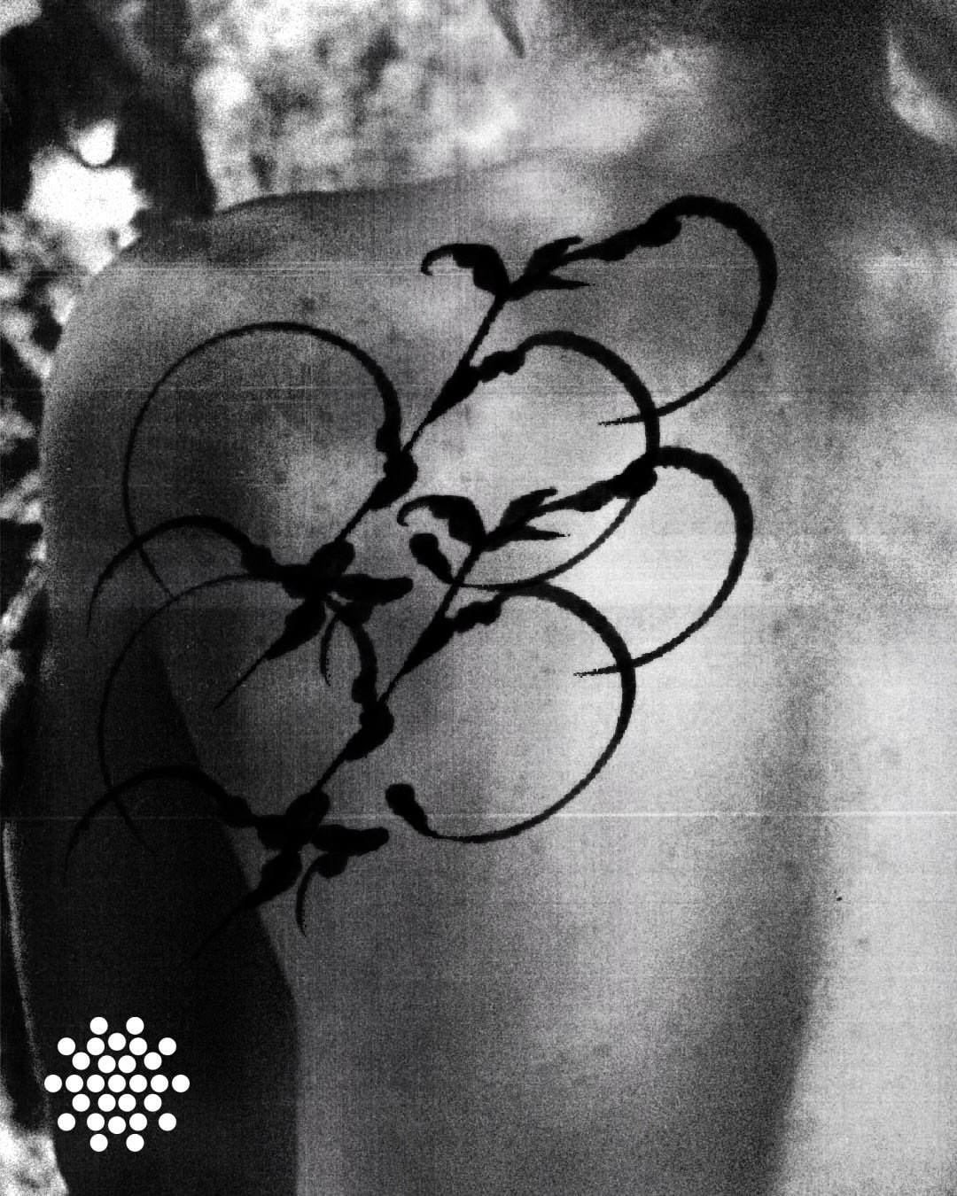 Floral vine black and grey tattoo on the thigh by San Kang
