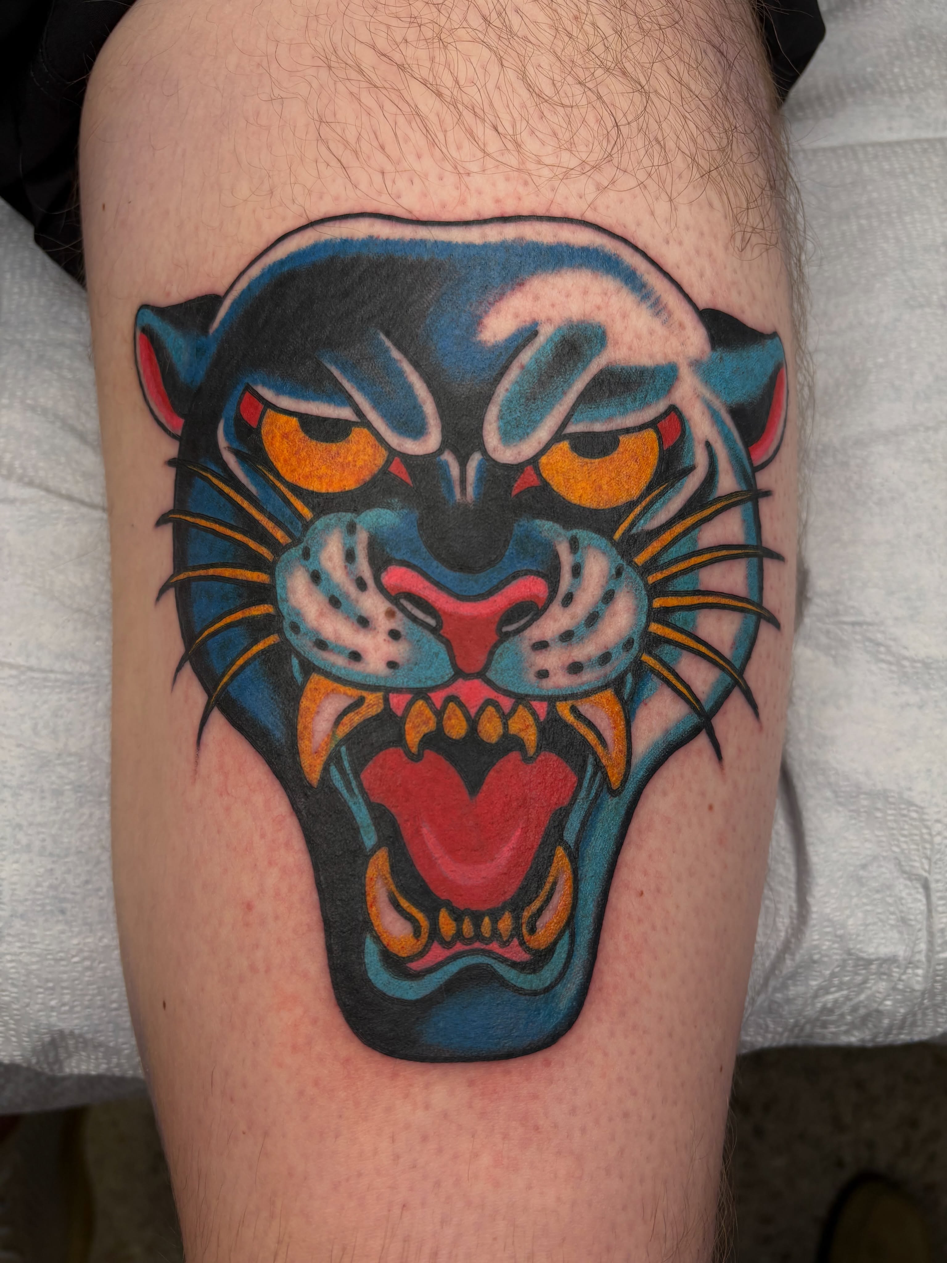 Panther head American traditional tattoo on the thigh by Dallas Tattoo Artist