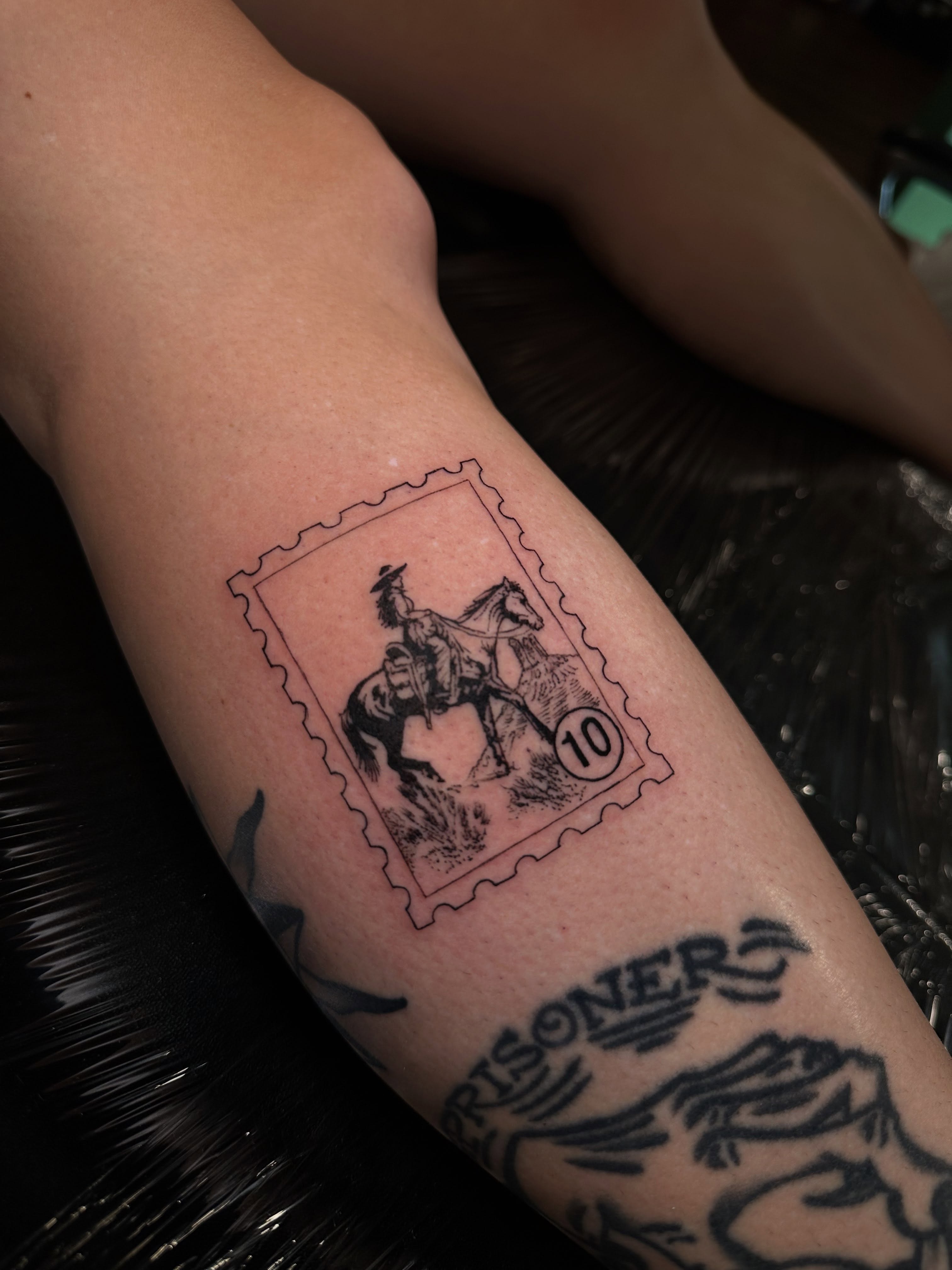 Cowboy on horse stamp black and grey tattoo on the forearm by Mario Flores Tattoo