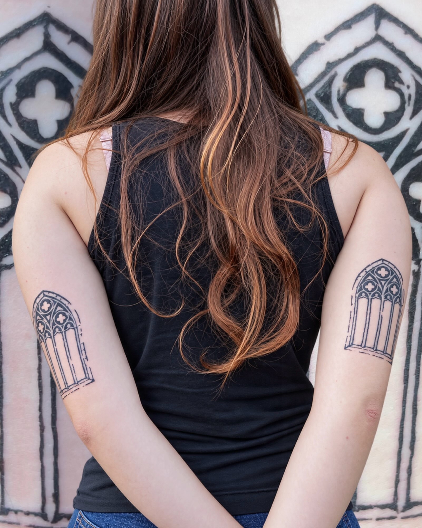 Gothic window black and grey tattoo on the upper arm by Adam
