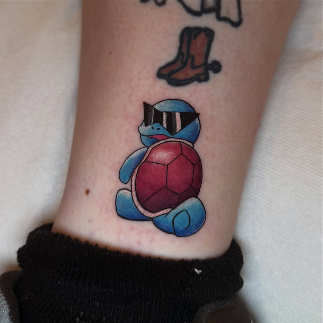 Squirtle wearing sunglasses new school tattoo on the forearm by Alexia