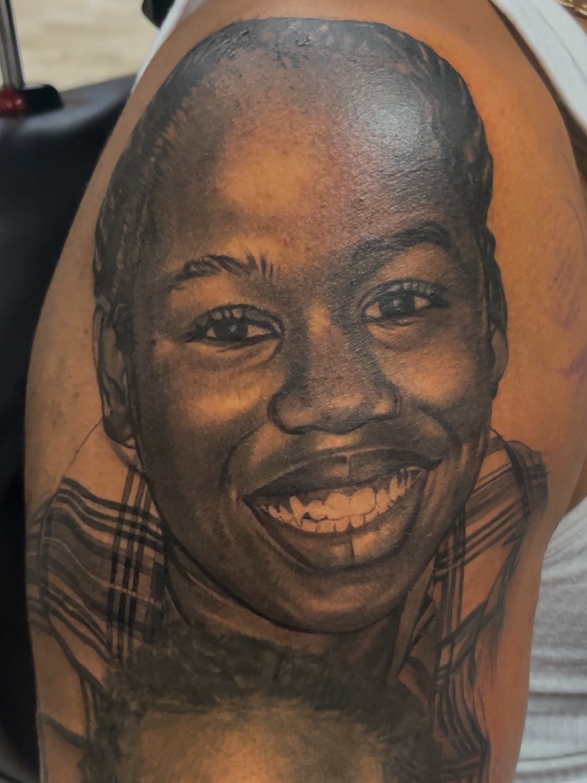 Portrait realism tattoo on the upper arm by Quinten Harper