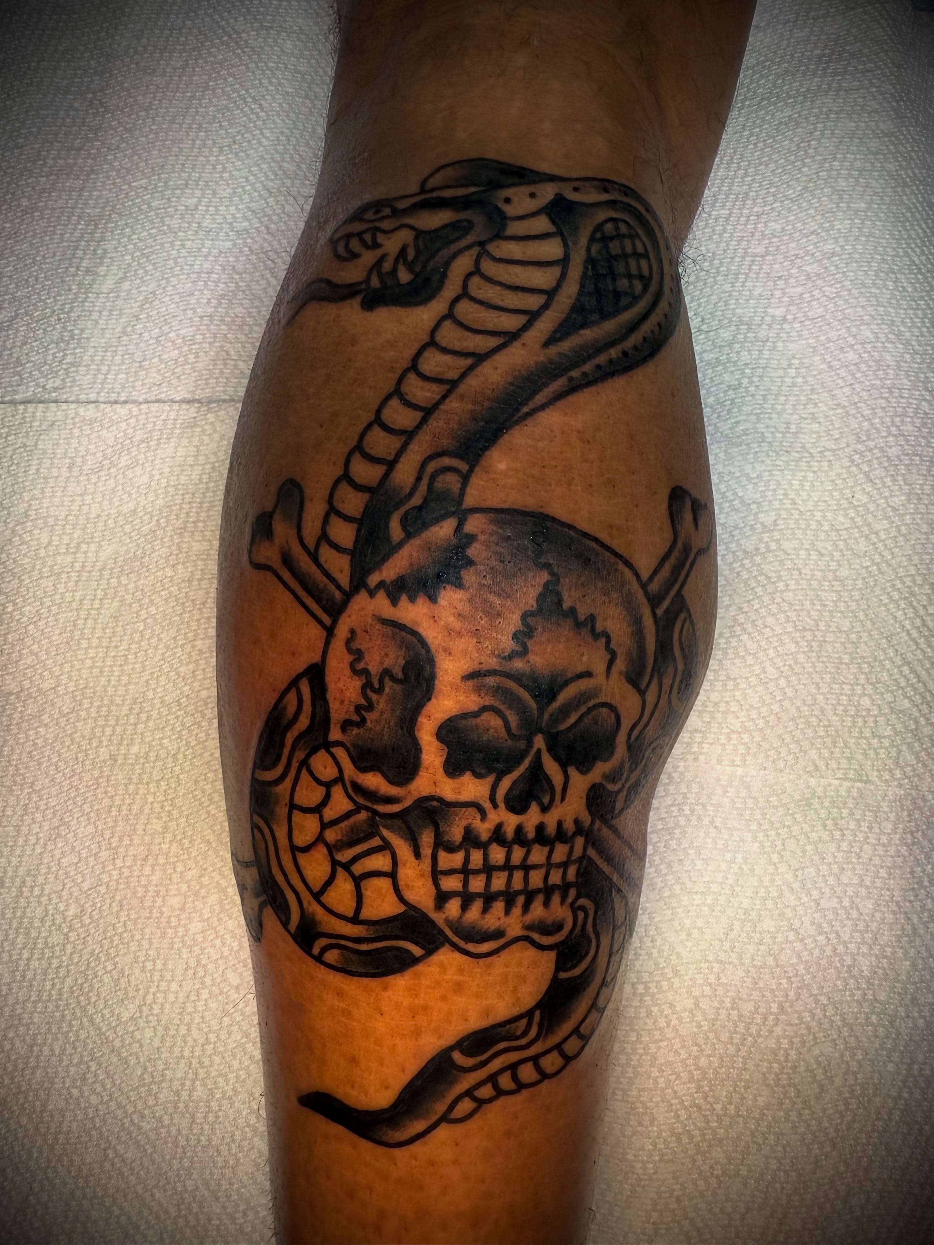 Snake and skull black and grey tattoo on the forearm by Victoria Lagano NYC Traditional Tattoos