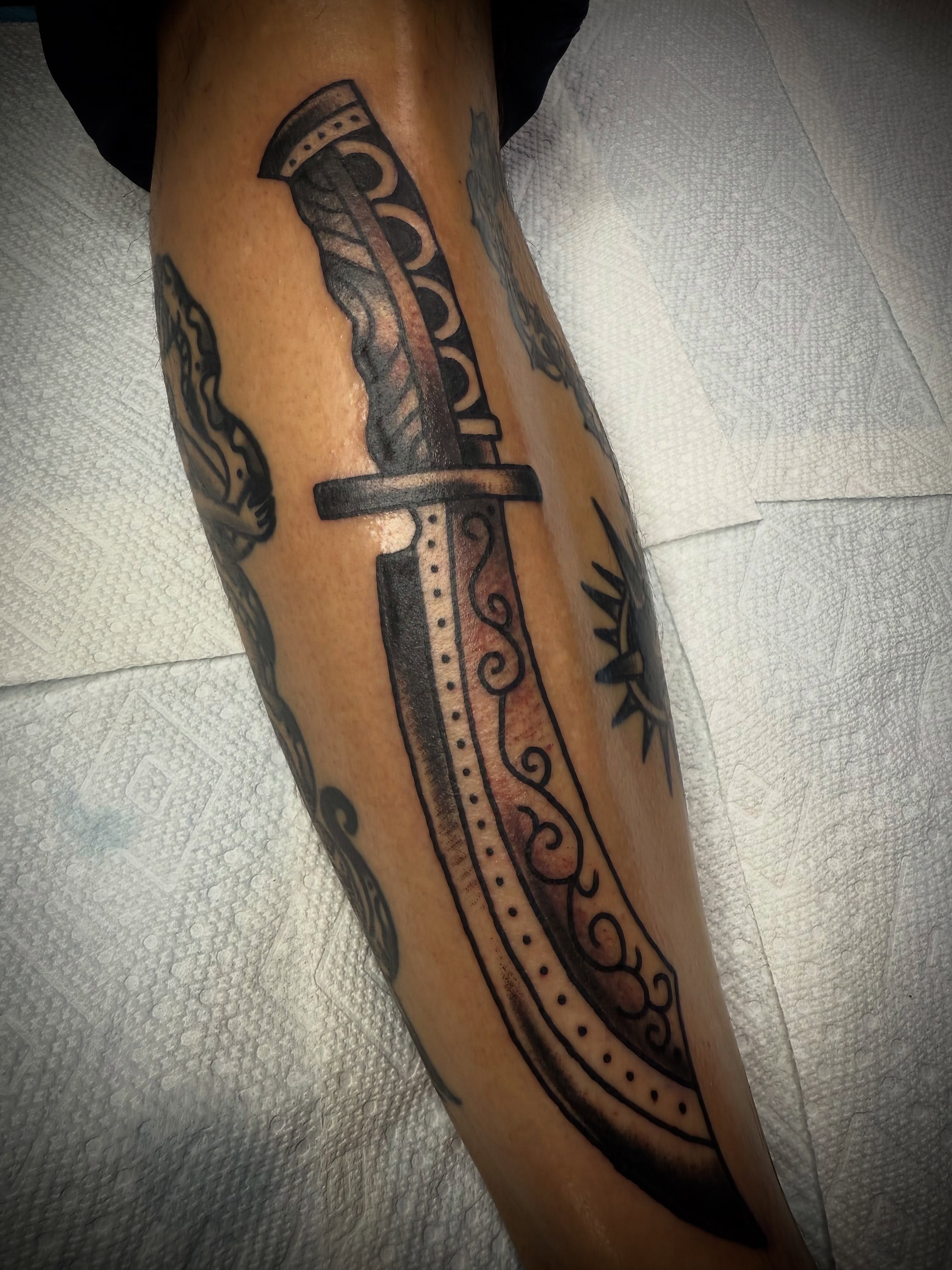 Knife black and grey tattoo on the forearm by Victoria Lagano NYC Traditional Tattoos