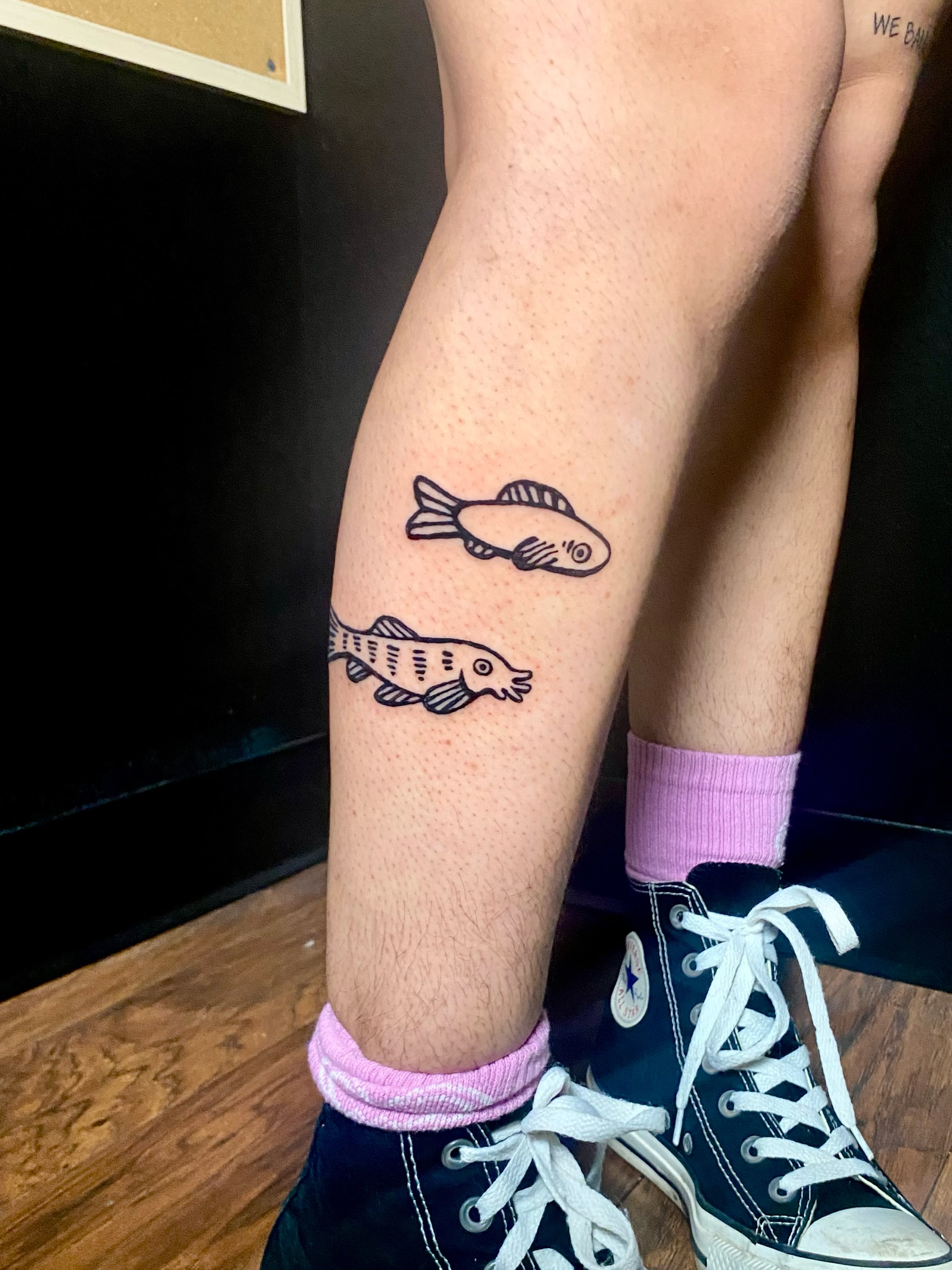 Fish minimalist tattoo on the leg by ollie, Portland, Oregon