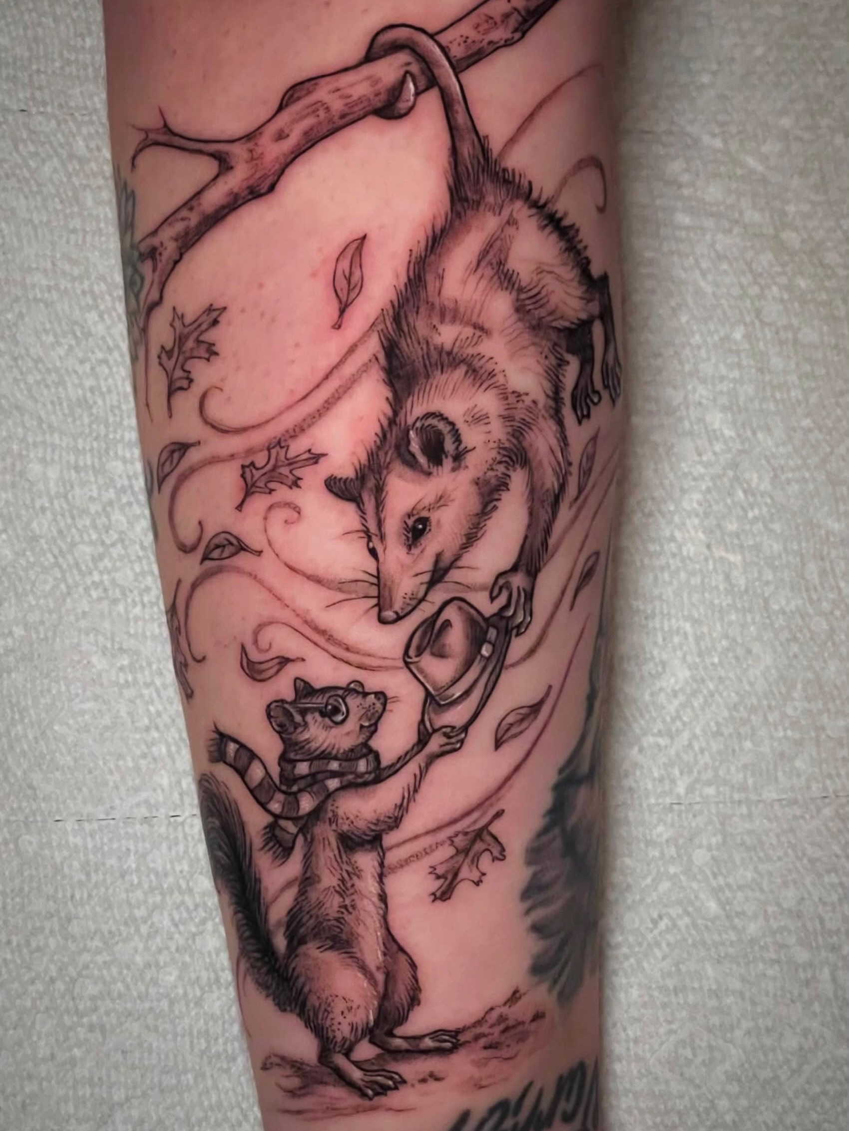 Possum and squirrel black and grey tattoo on the forearm by Sam DiBiase