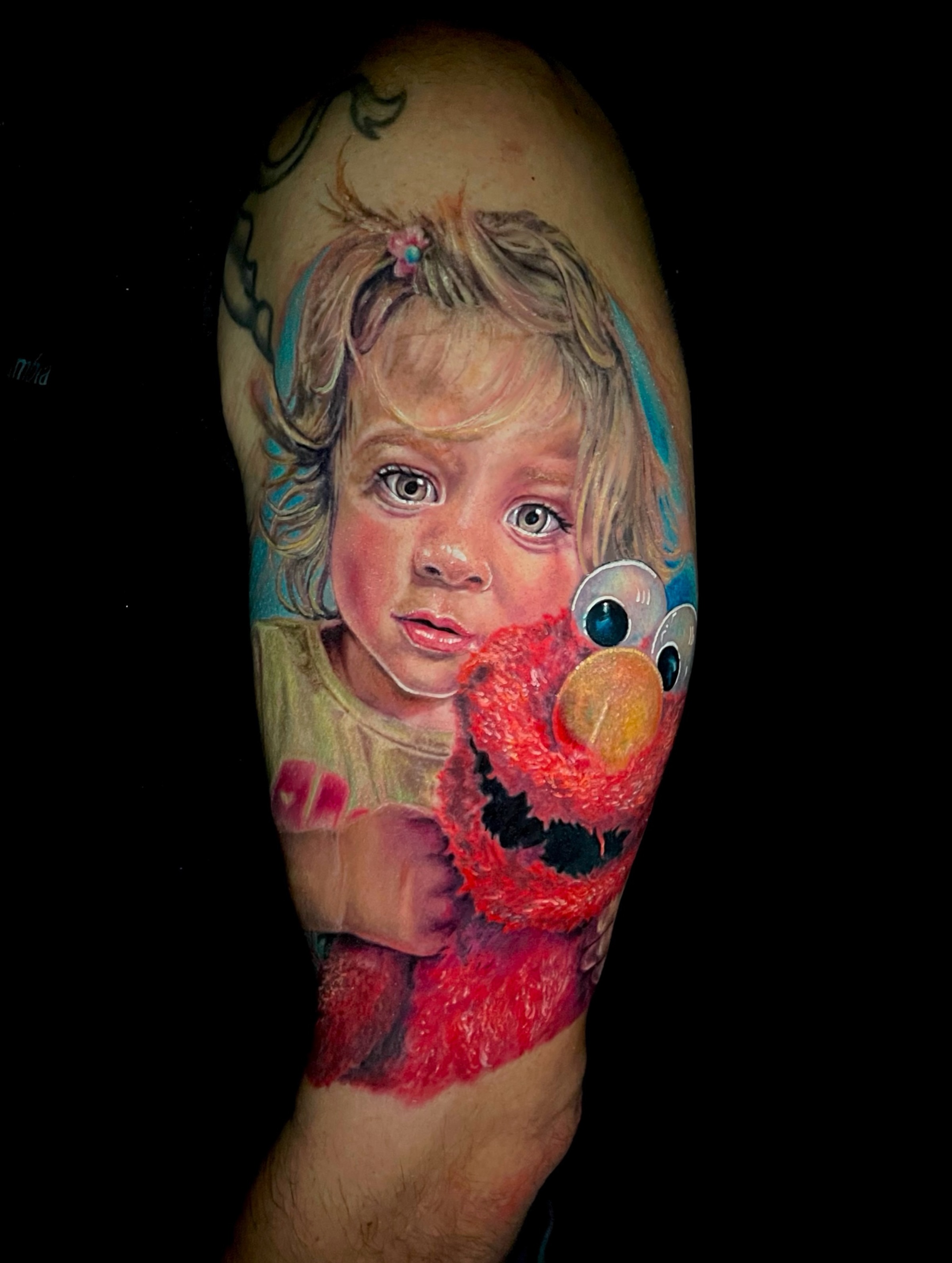 Child and Elmo realism tattoo on the forearm by Amber Joy (AJ)