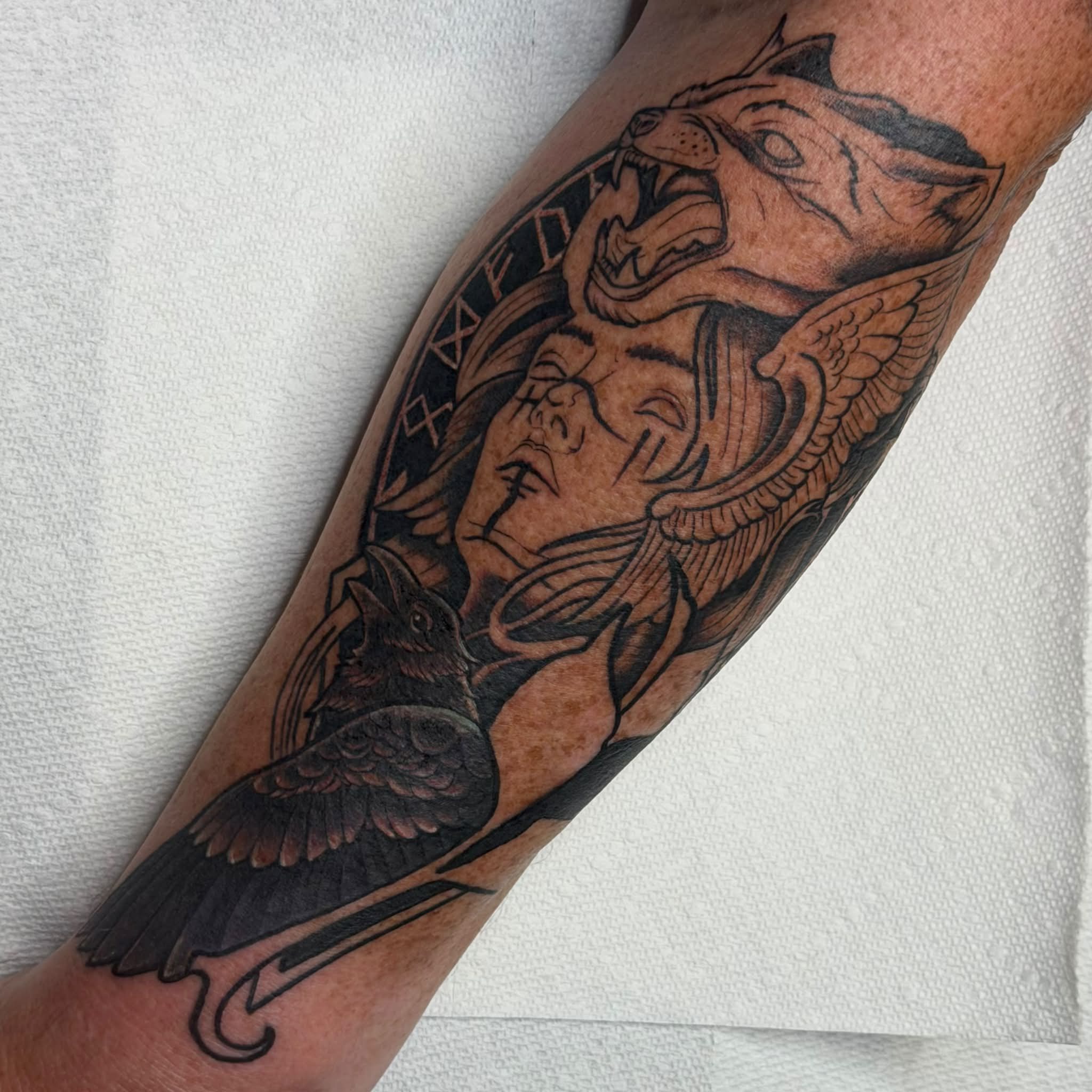 Woman with bird and wolf realism tattoo on the forearm by Kenneth Prince