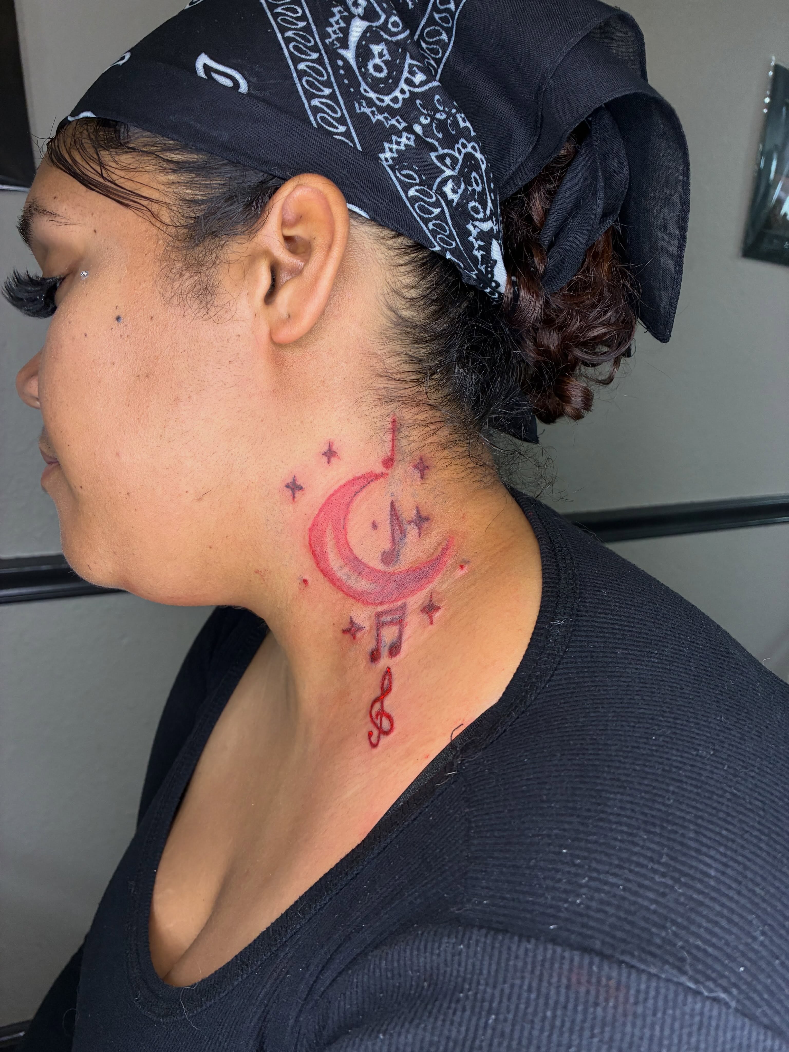 Musical notes and crescent moon dotwork tattoo on the neck by 702tattoo💉🩸