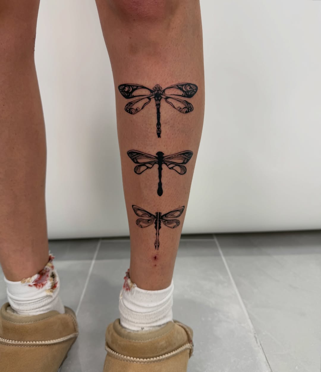 Dragonfly black and grey tattoo on the leg by Alex