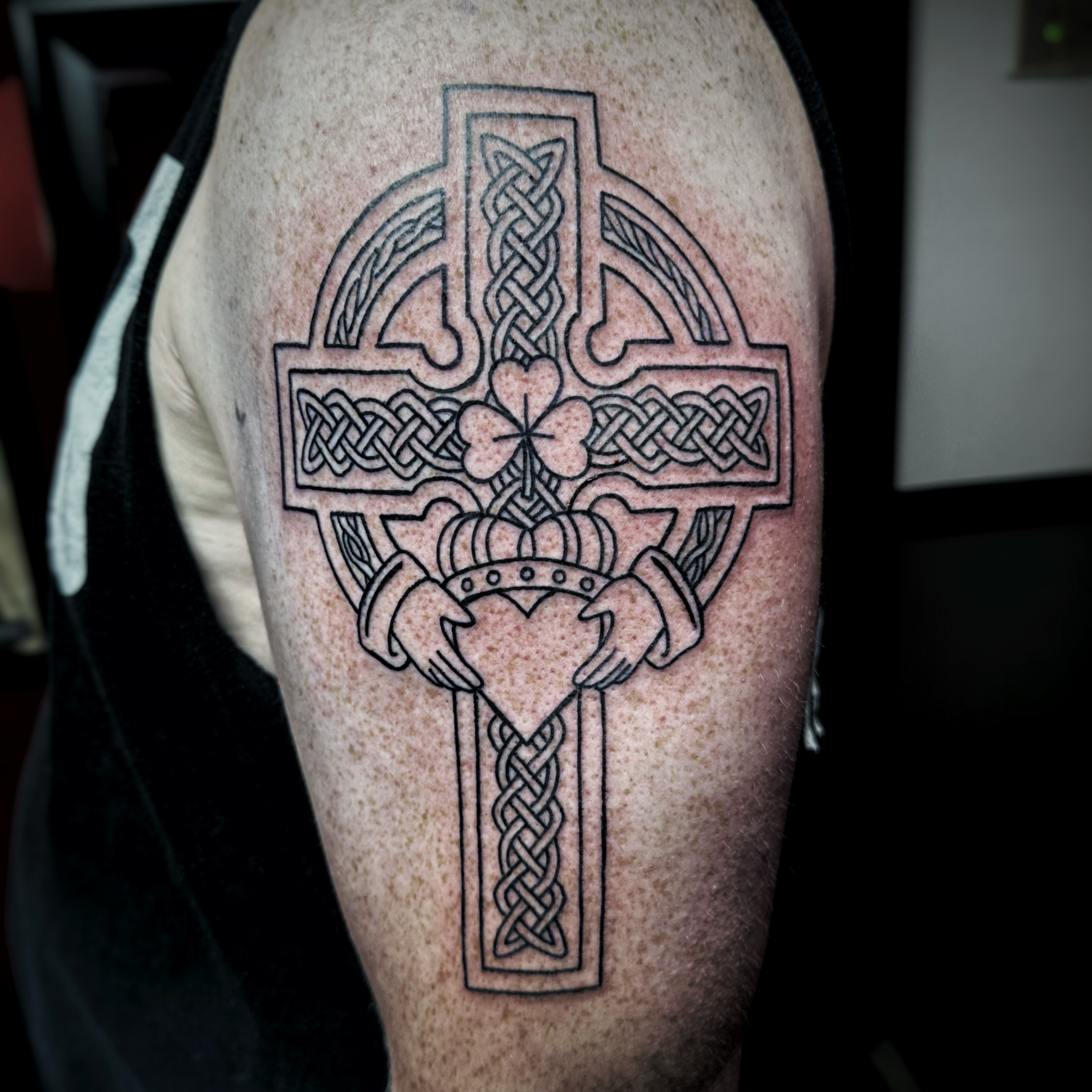 Claddagh cross black and grey tattoo on the forearm by Anthony Guido