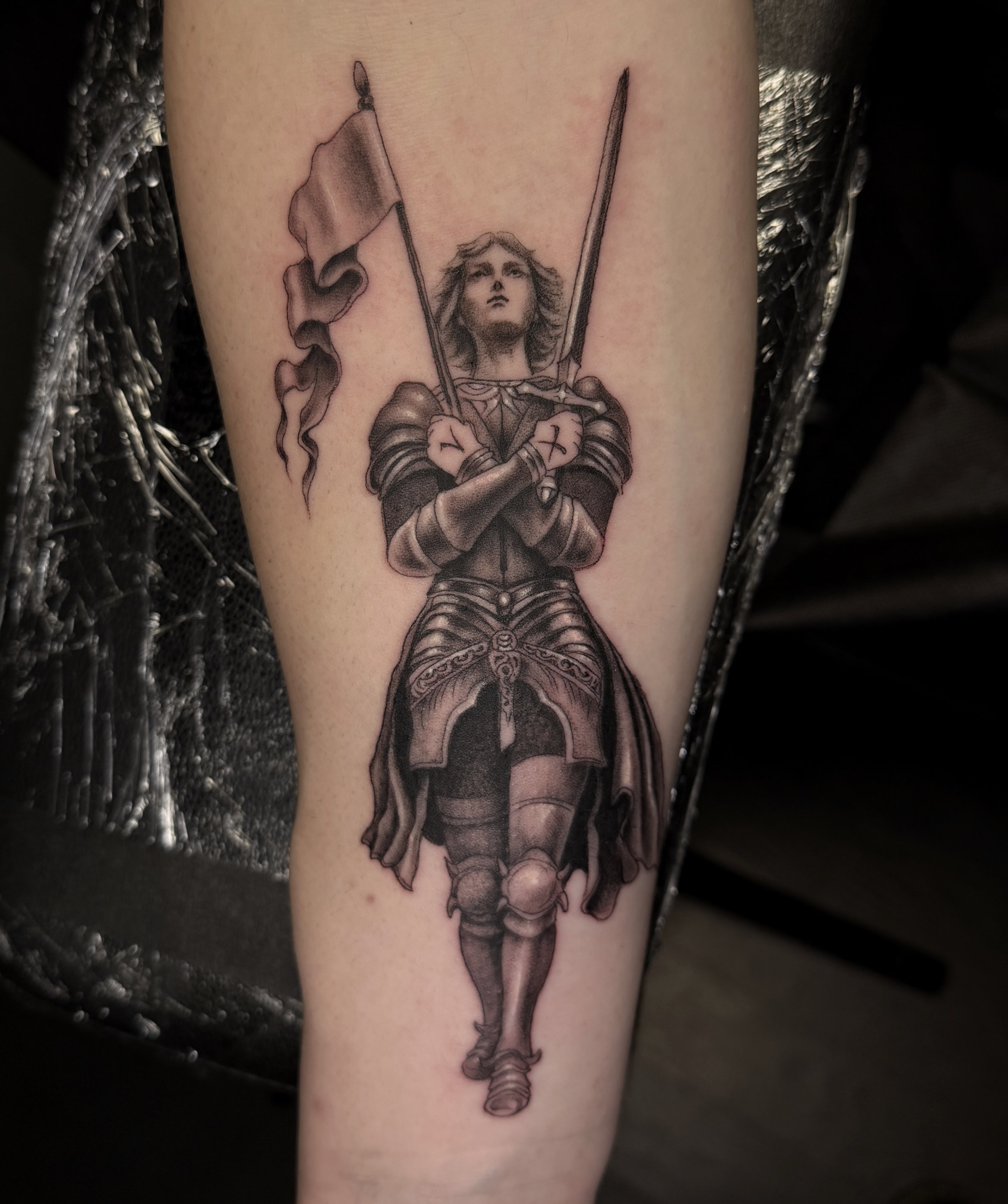 Knight with flag realism tattoo on the forearm by Madeleine Fleming