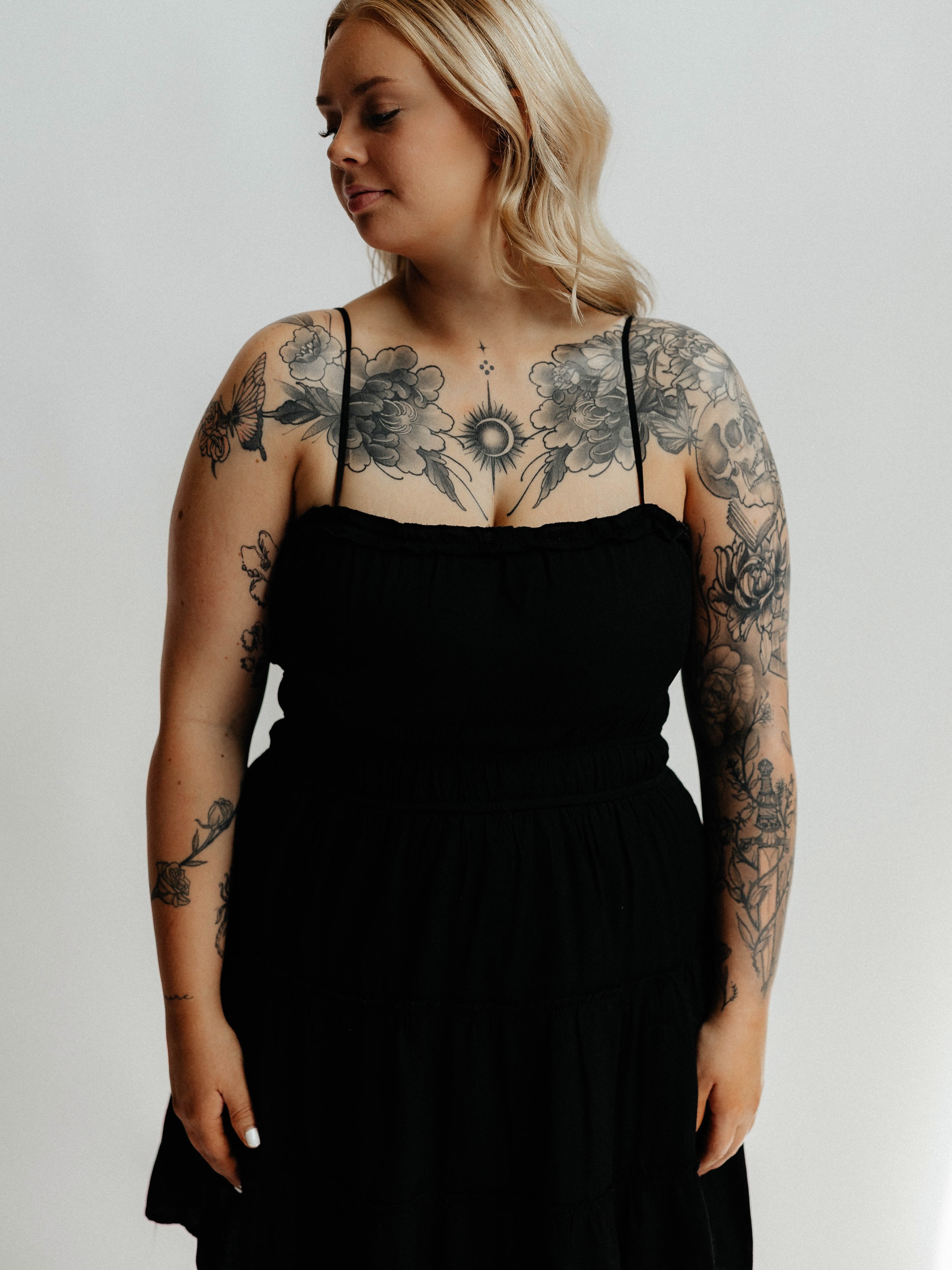 Floral and celestial black and grey tattoo on the chest by Srey Grace