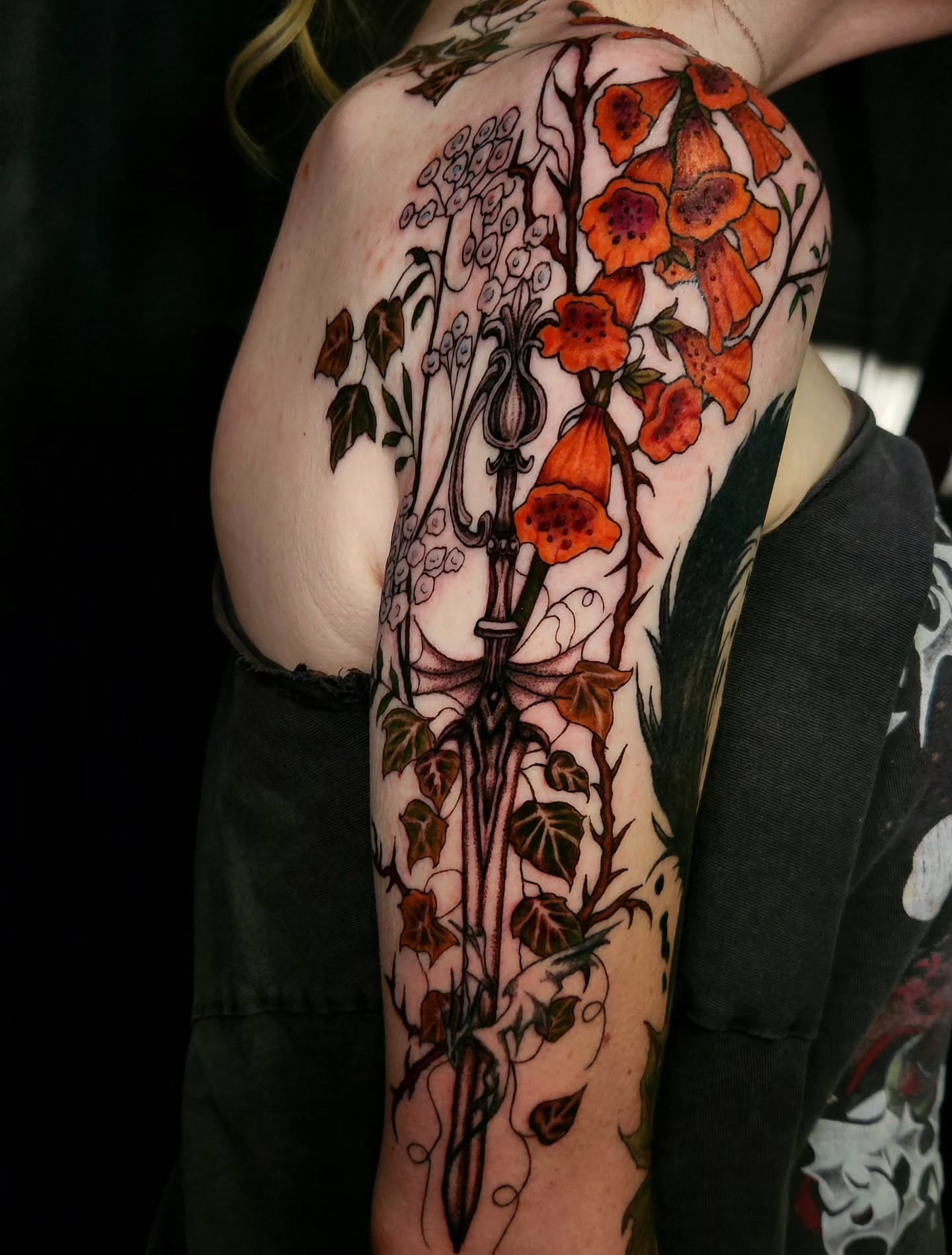 Floral arrangement ornamental tattoo on the upper arm by Ashly Renee