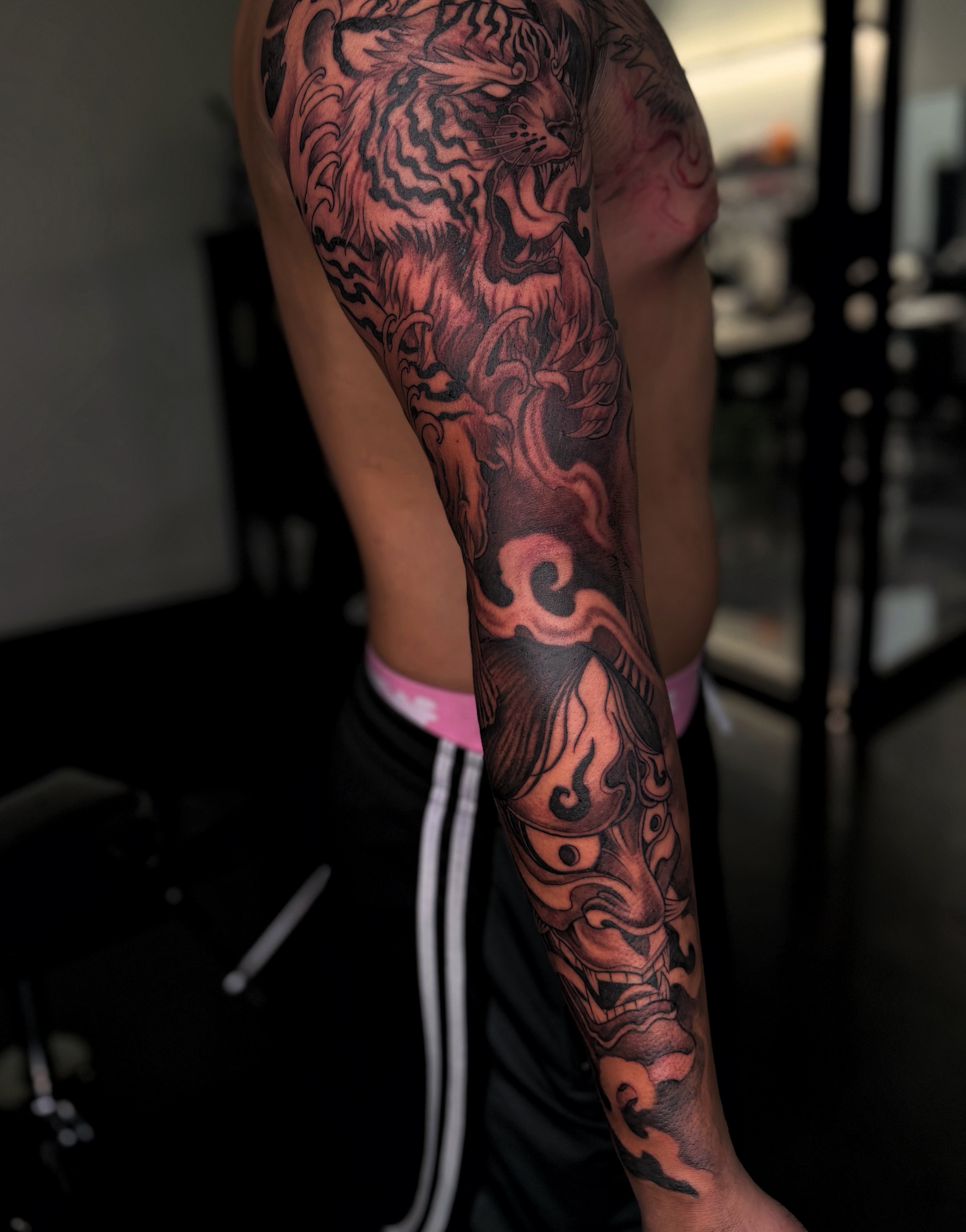 Tiger and mask japanese irezumi tattoo on the forearm by Melissa "Lotuss" Chan