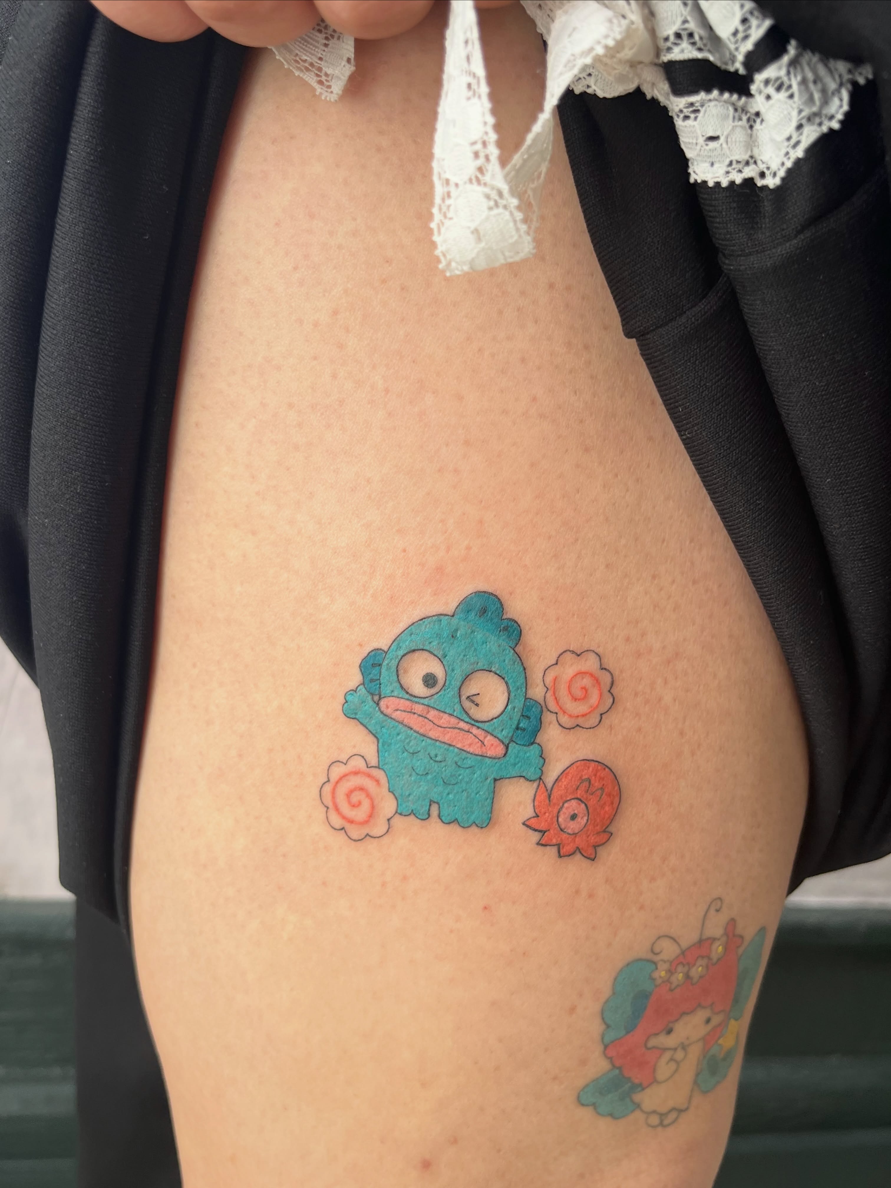 Monster and flower dotwork tattoo on the thigh by Kyra Monterrosa