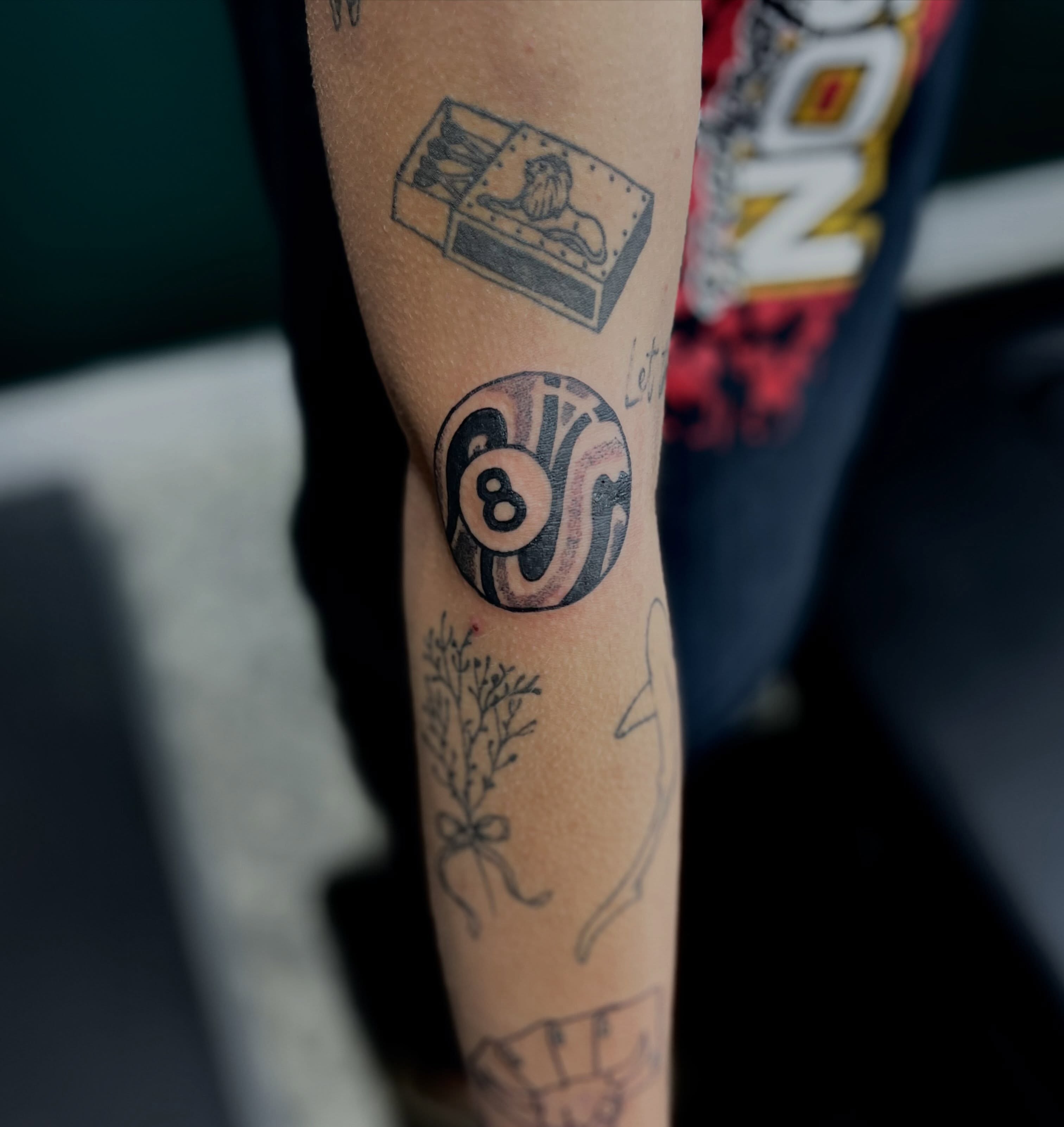 8-ball black and grey tattoo on the forearm by Mason McCubbin