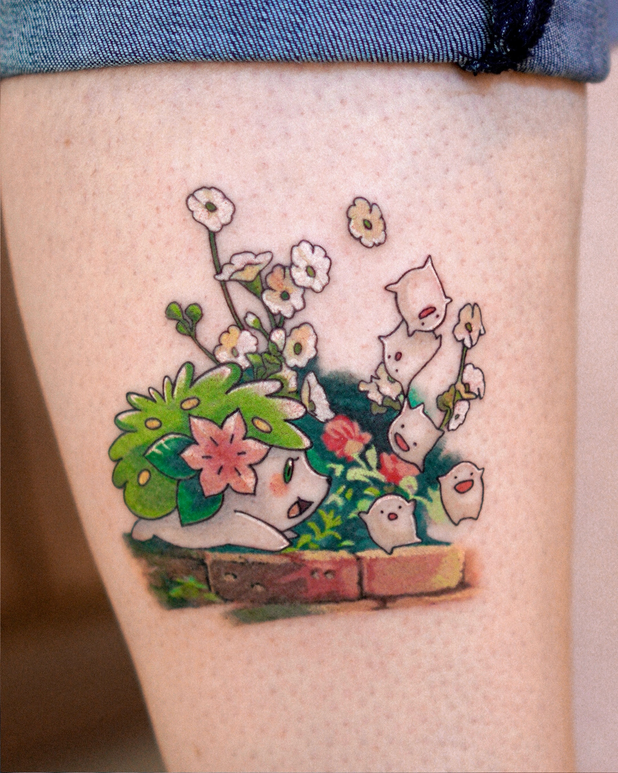 Chibi characters in garden dotwork tattoo on the thigh by Eden