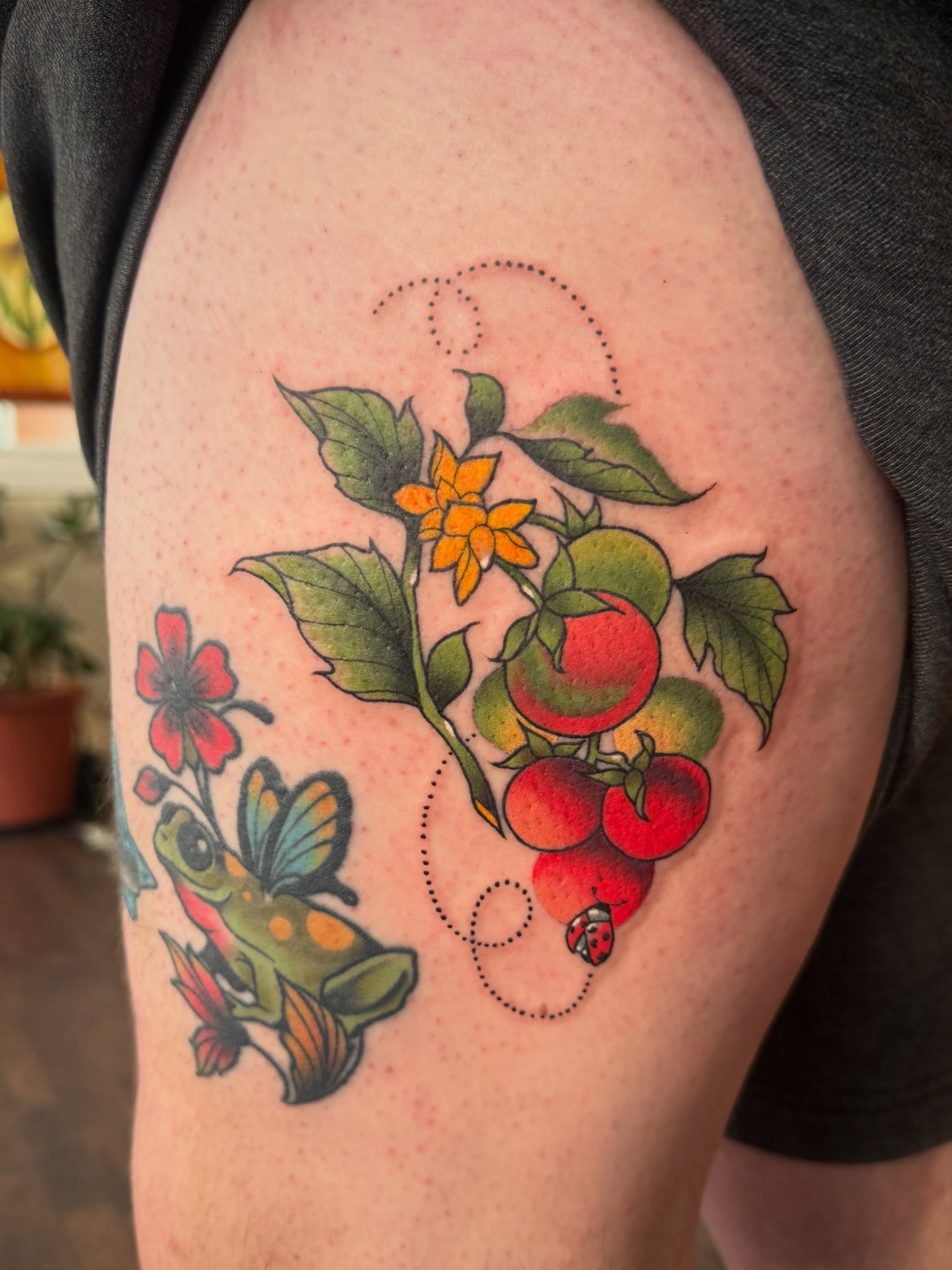 Tomatoes, butterfly, flower, ladybug American traditional tattoo on the upper arm by Alisa (Li) Affatato ๐ผ