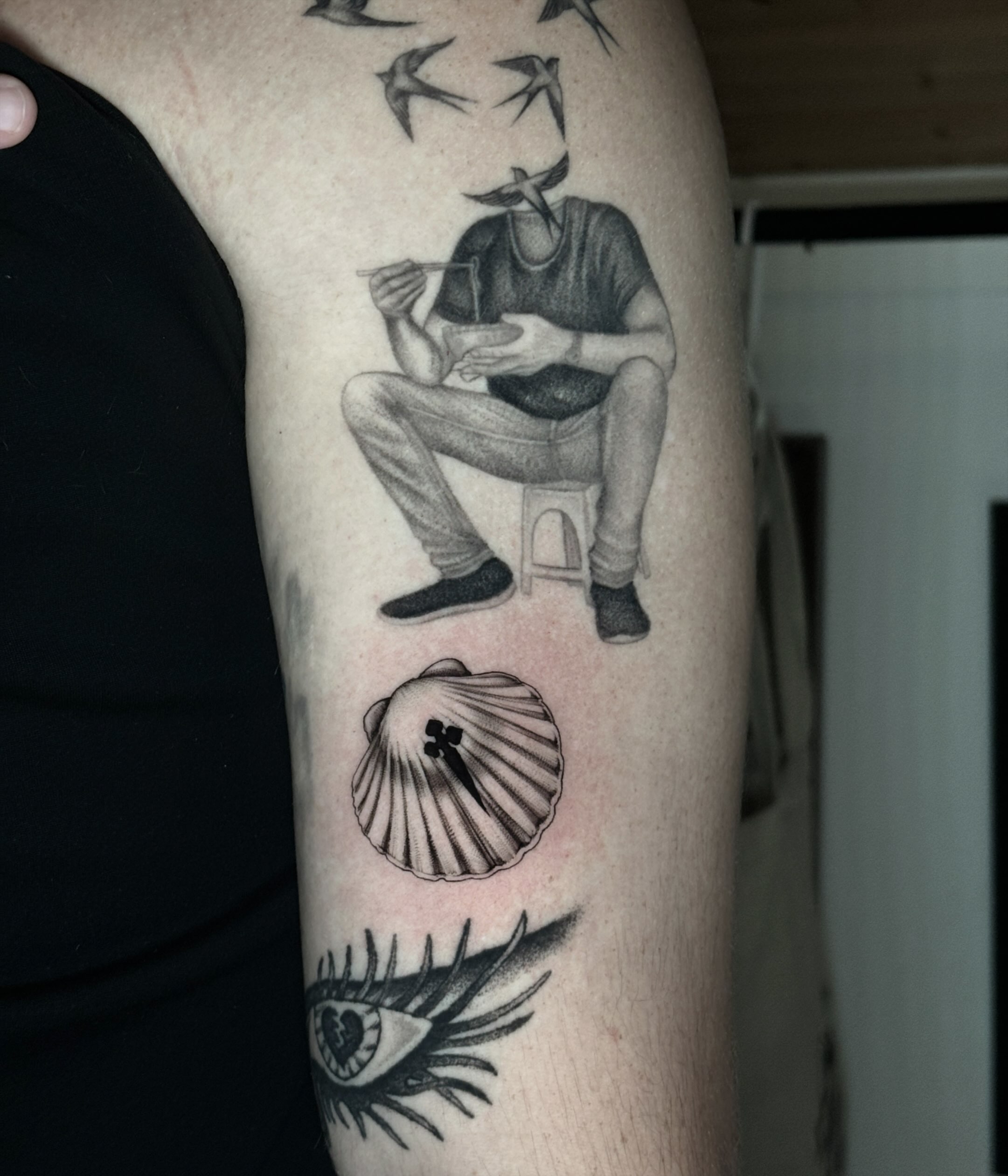 Man eating noodles black and grey tattoo on the forearm by Emma Cotter