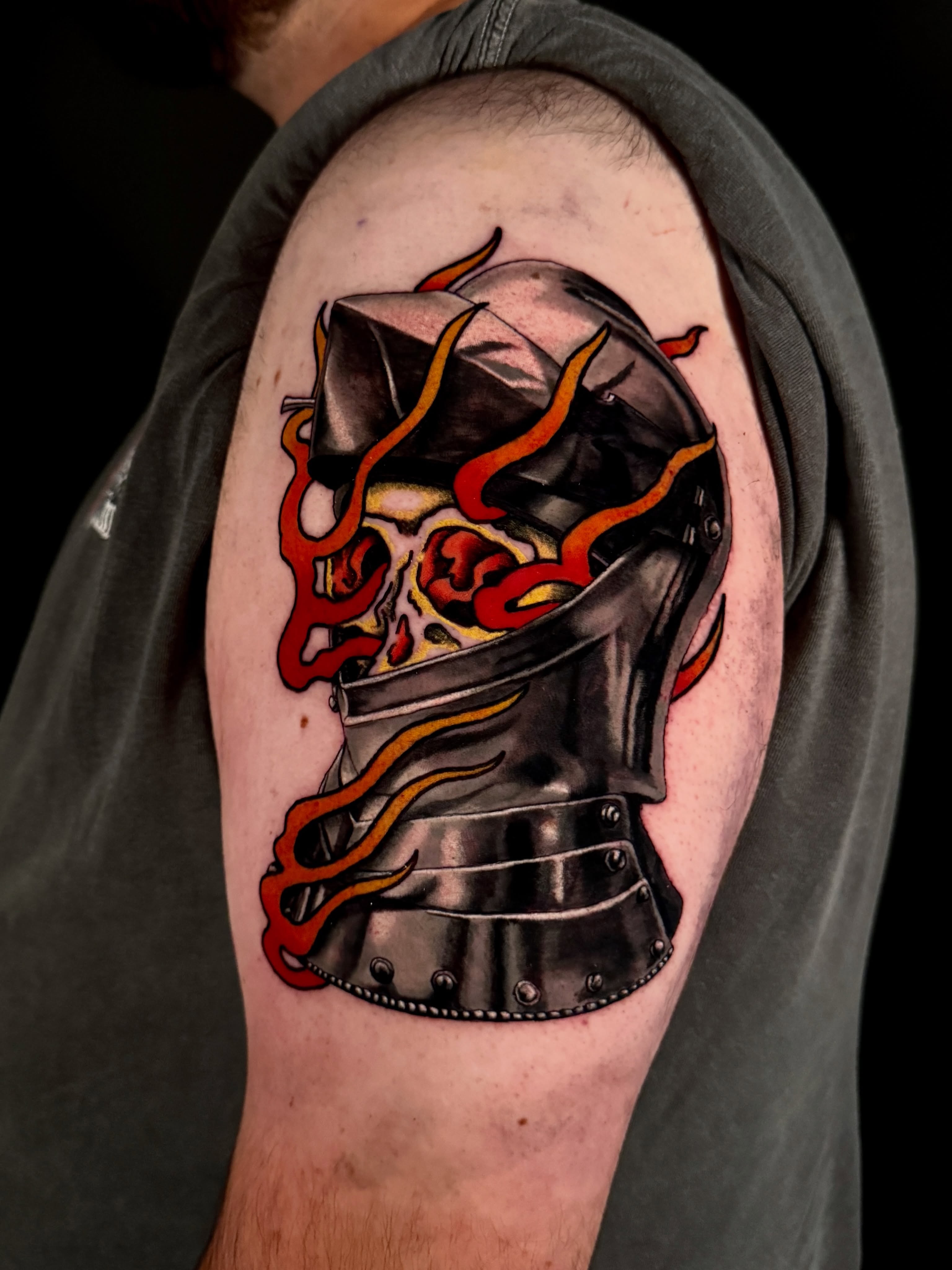 Helmet with flames dark realism tattoo on the shoulder by Dallas Tattoo Artist