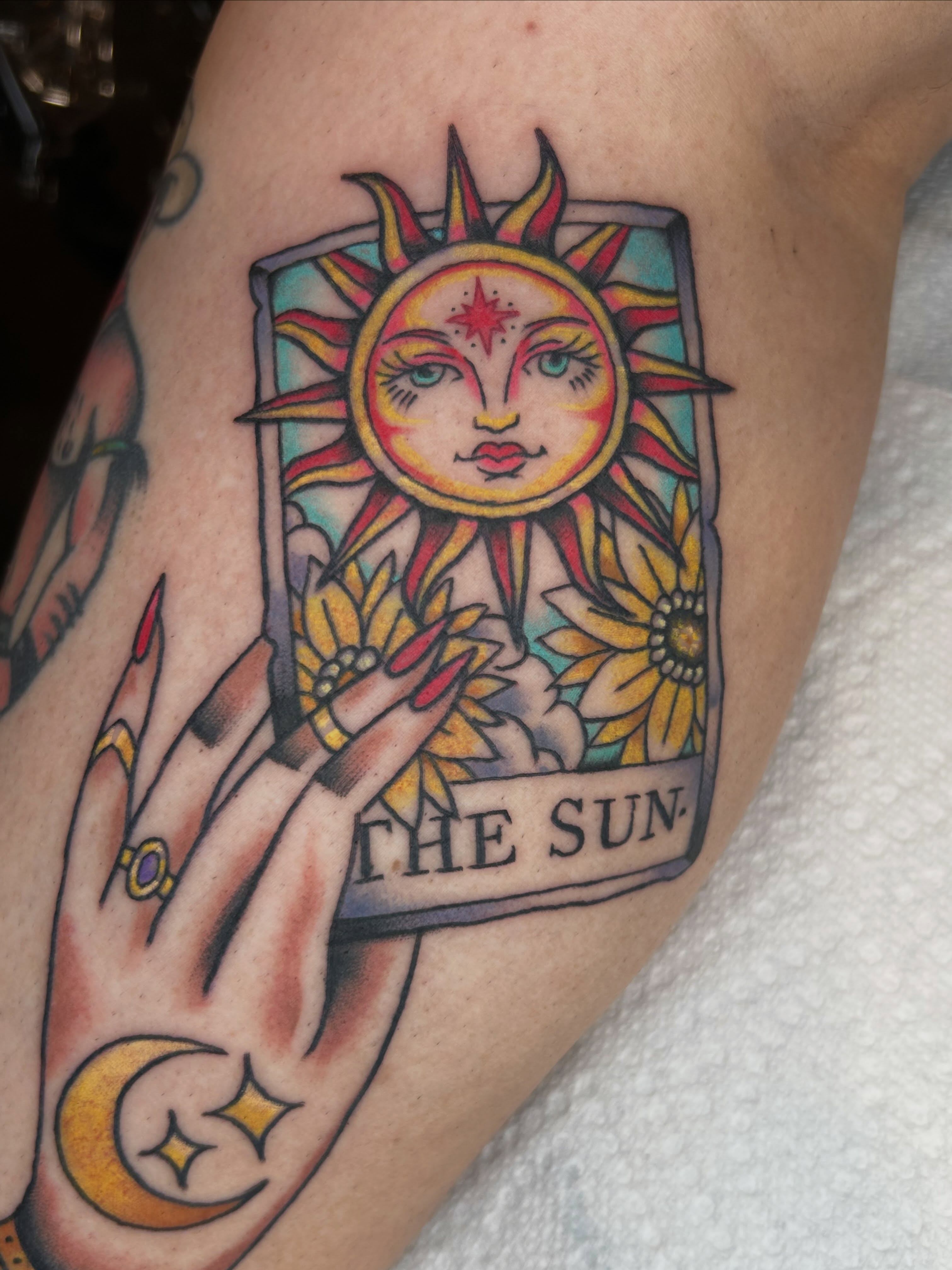 The sun tarot card American traditional tattoo on the forearm by Cassidy Hammer, Westland, Michigan
