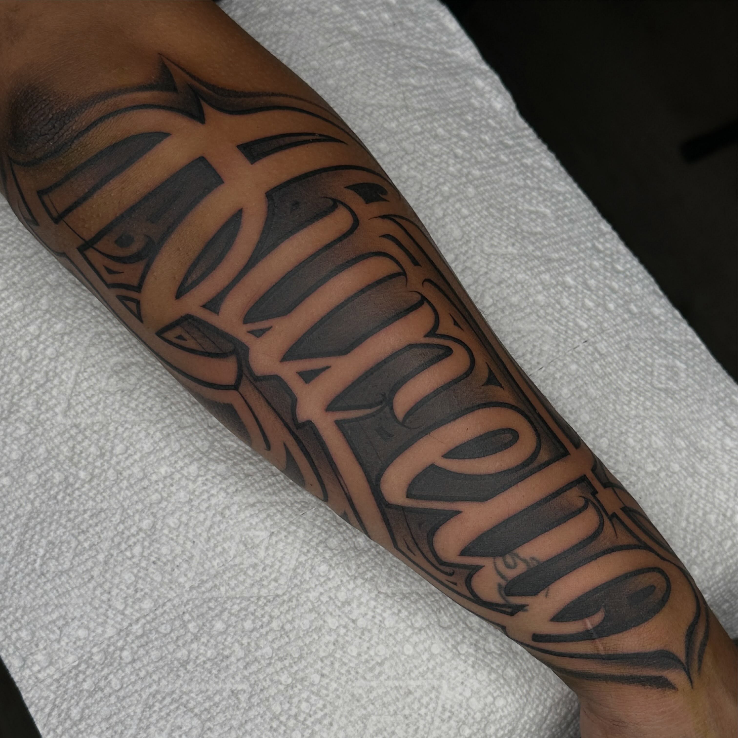 Script lettering lettering script tattoo on the forearm by San Diego Tattoo Artist