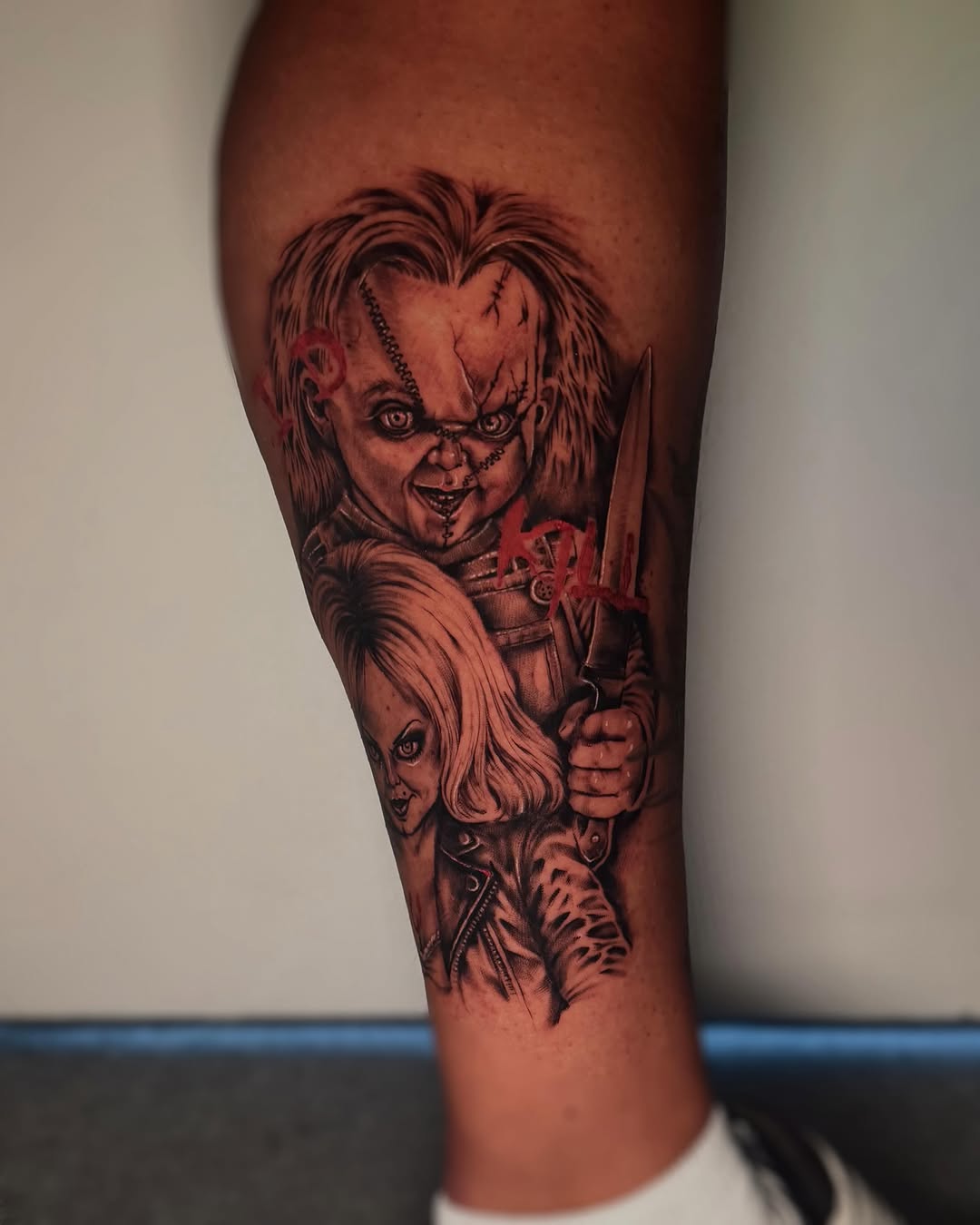 Chucky realism tattoo on the thigh by Emma Mathis, Springfield, Oregon