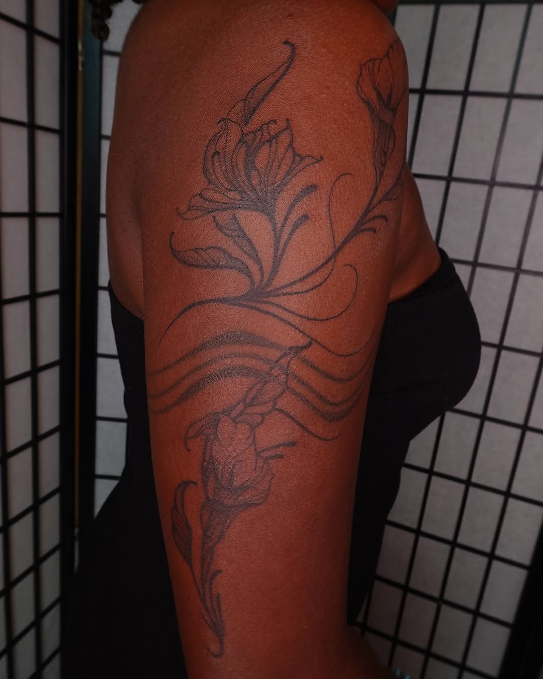 Floral design black and grey tattoo on the upper arm by jun