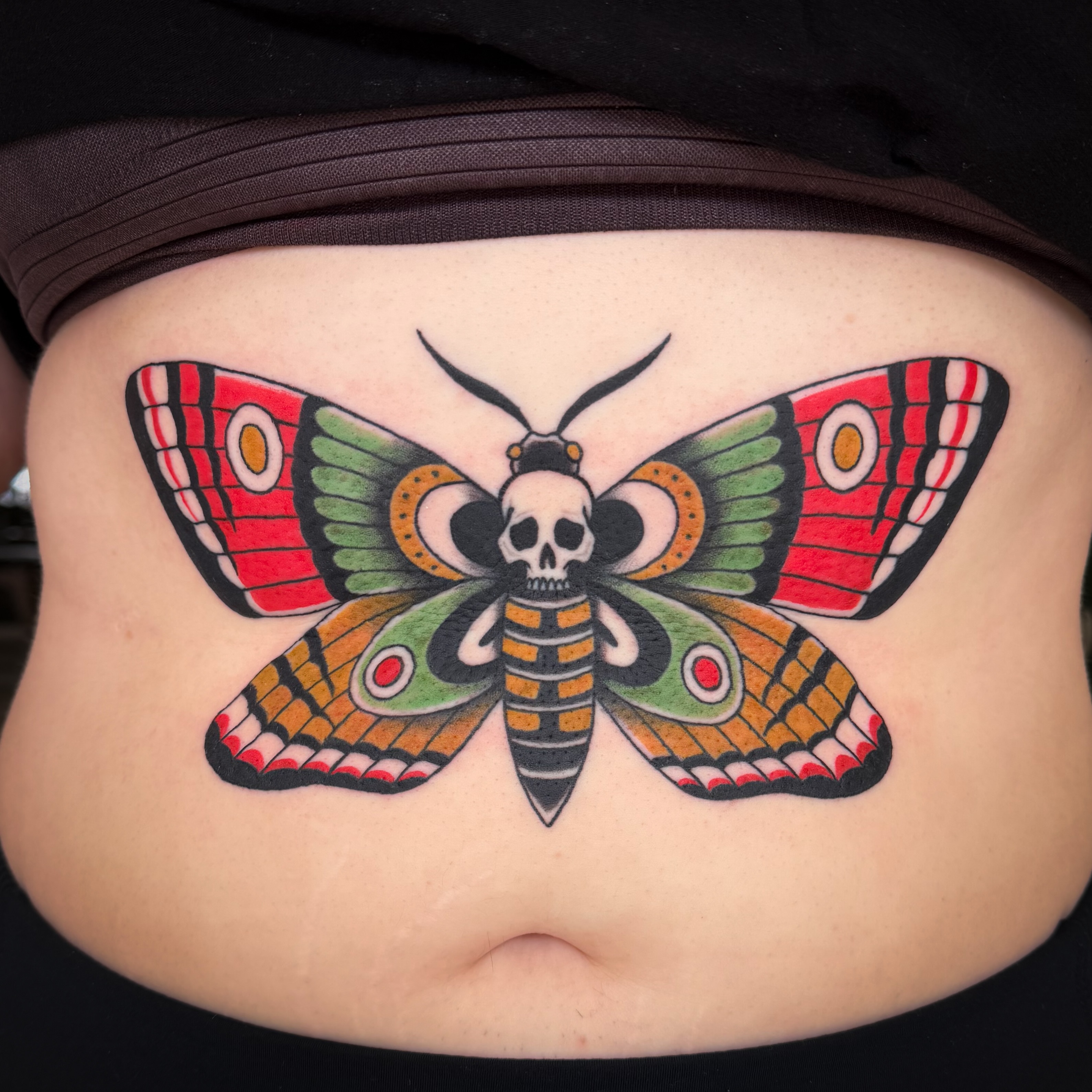 Butterfly with skull American traditional tattoo on the torso by Jessica Oram Brockman, Dayton, Ohio
