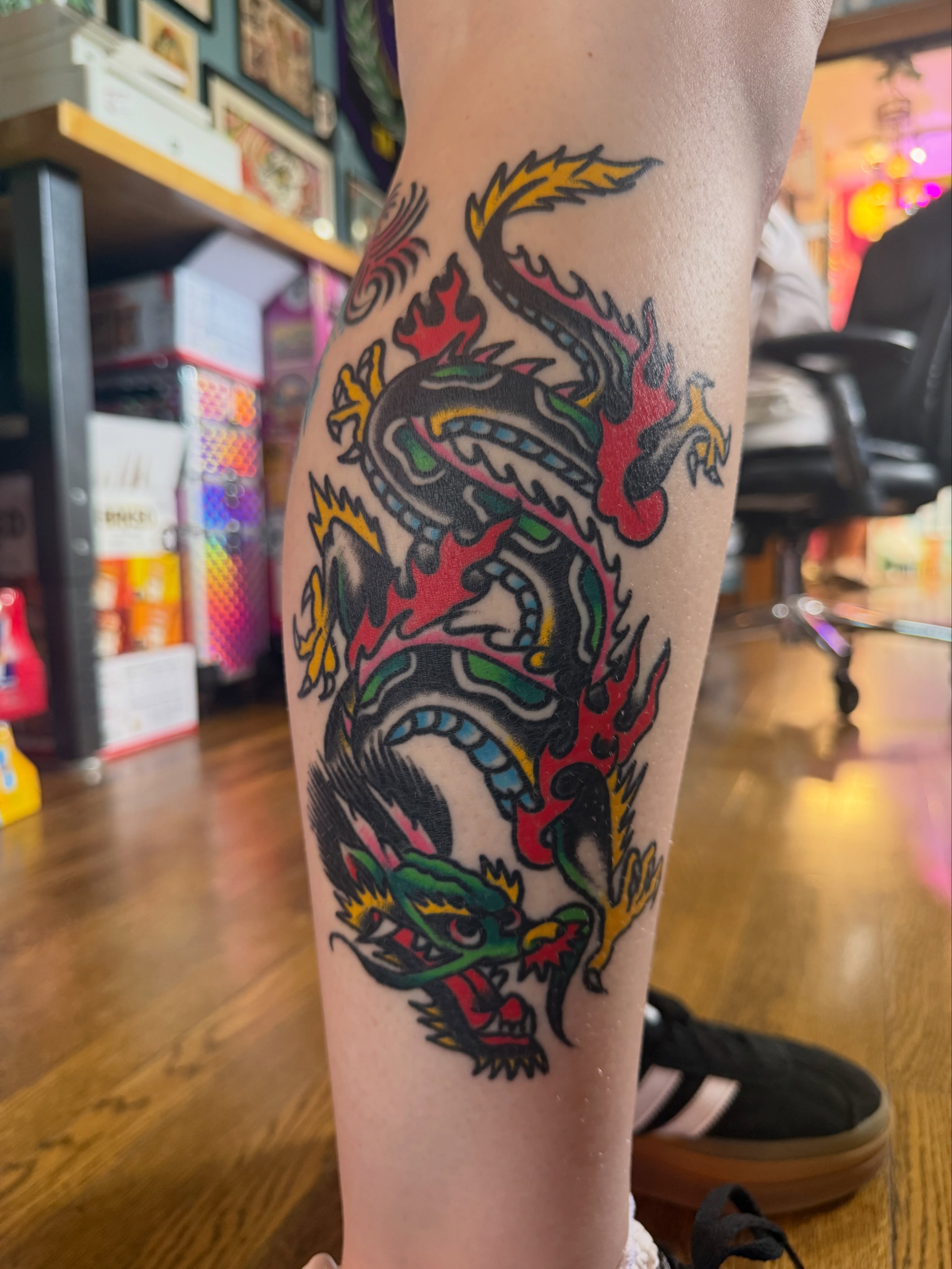 Dragon American traditional tattoo on the thigh by Chuck Derek Whitaker
