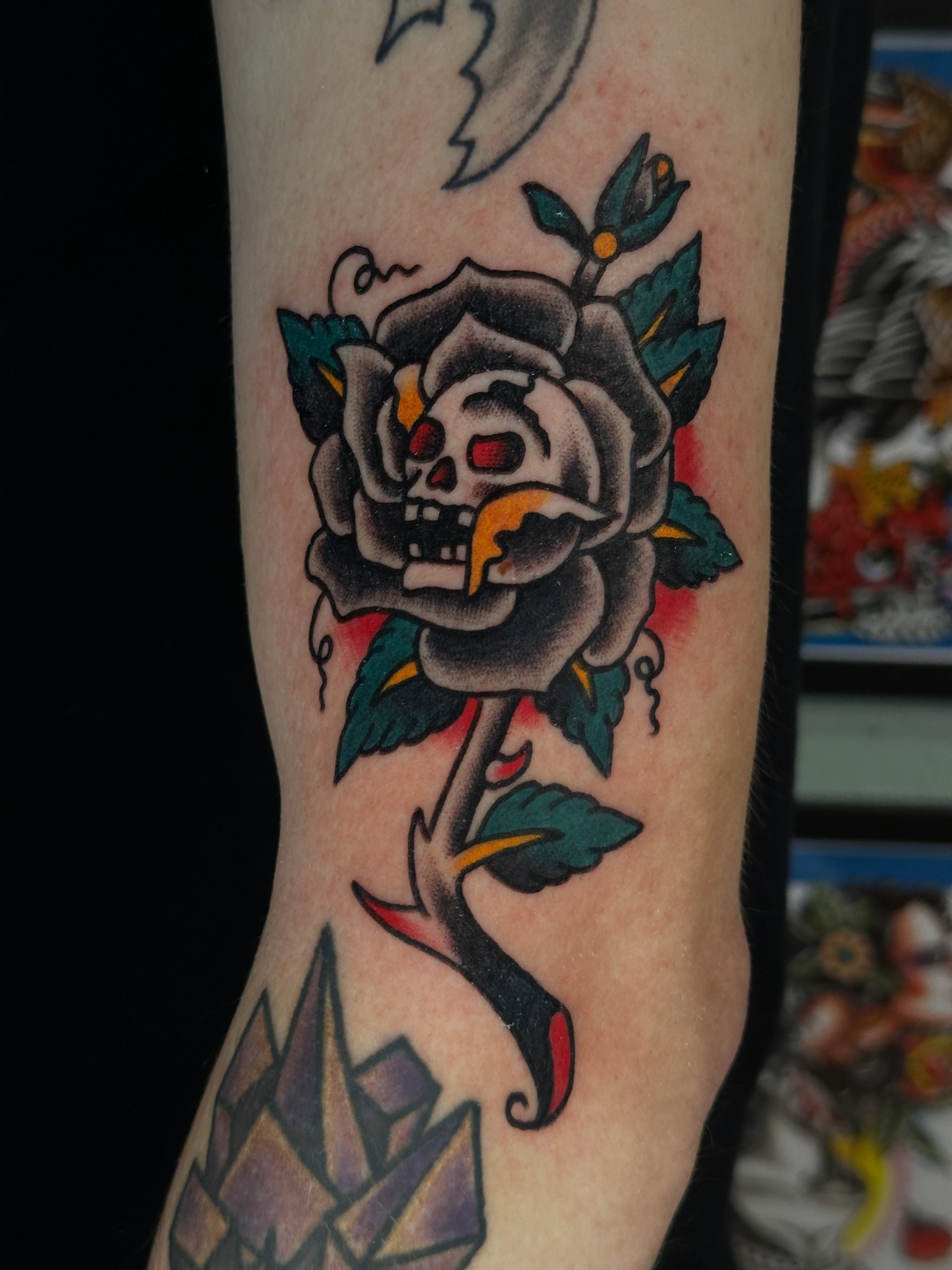 Skull and rose American traditional tattoo on the forearm by Jared, Addison, Texas