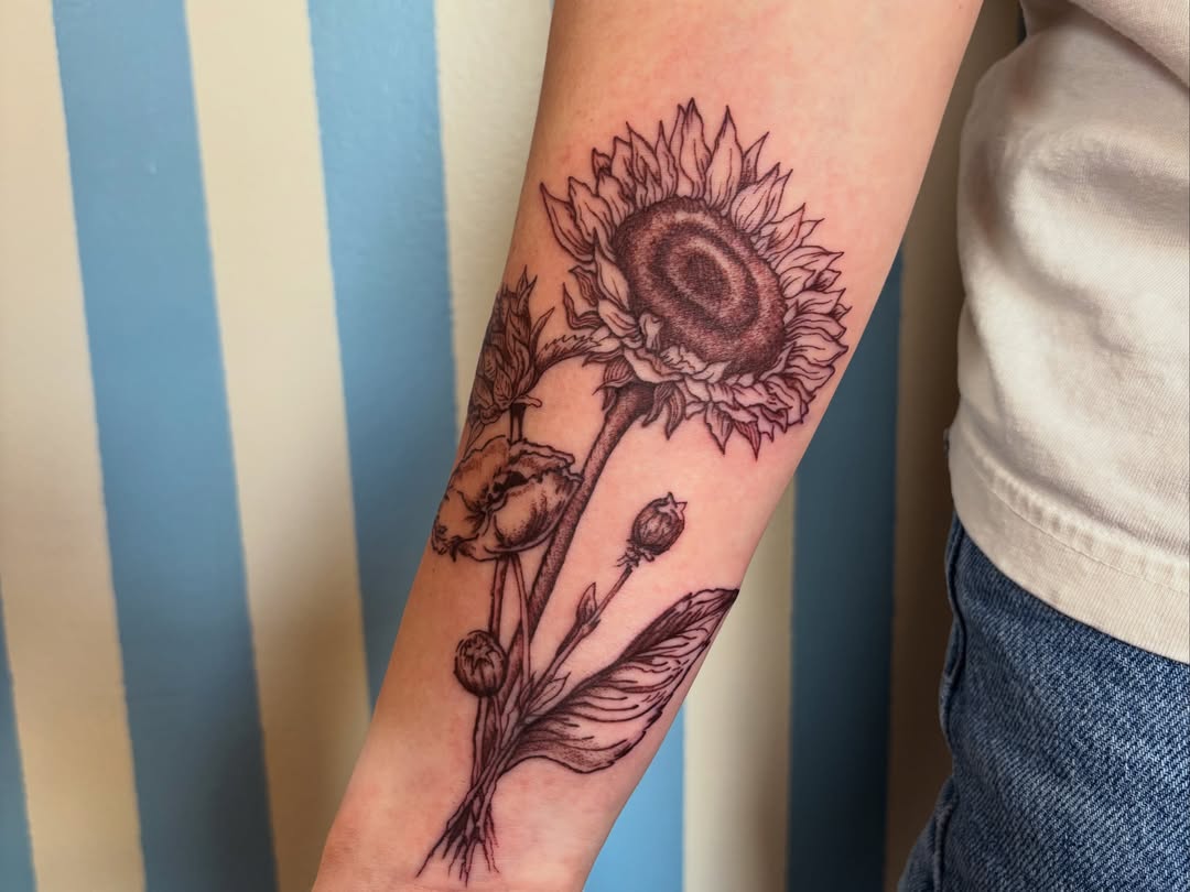 Sunflower and poppies black and grey tattoo on the forearm by Ashley Ellerman